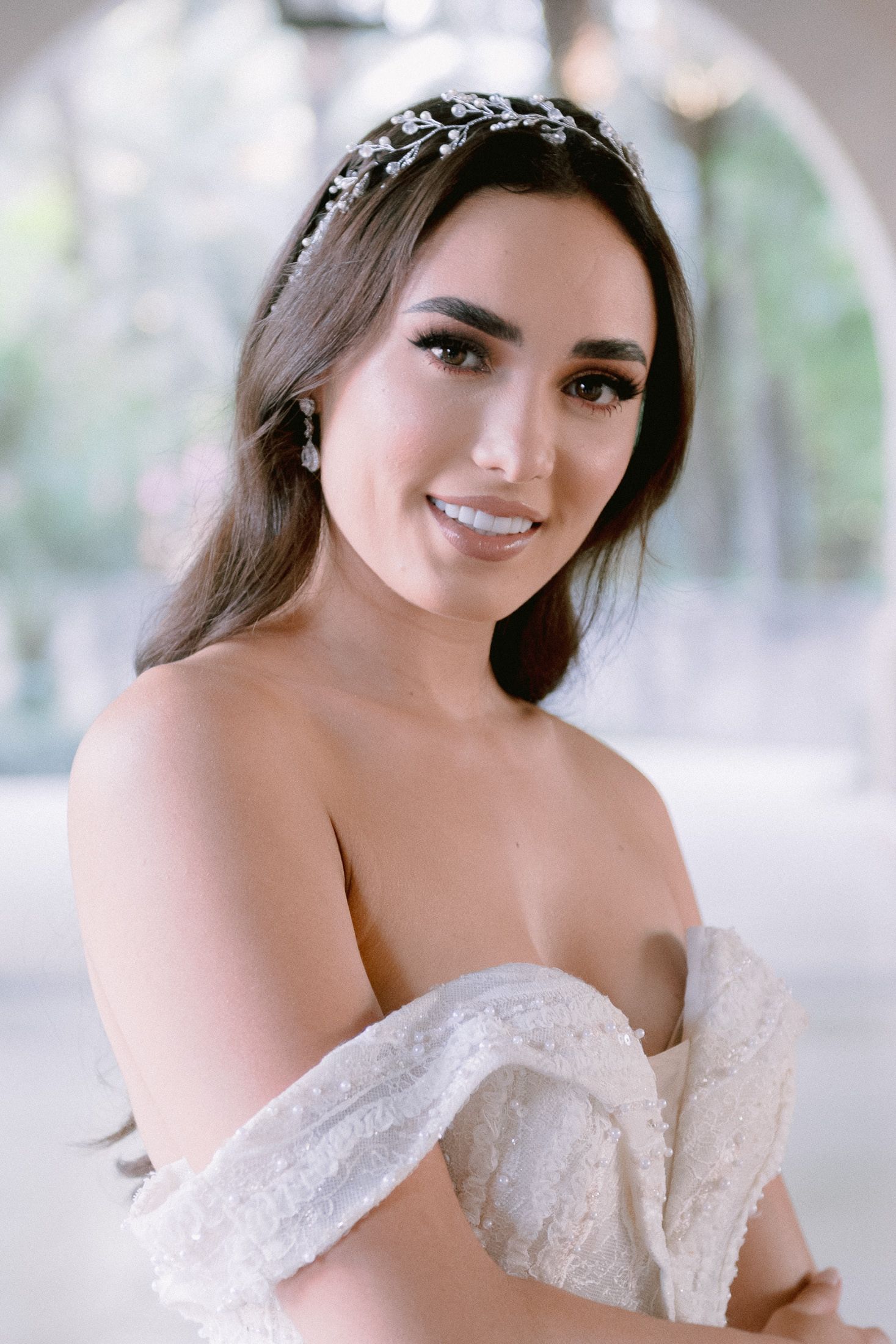 Natural light bridal portraits featuring a detailed off-shoulder wedding gown.