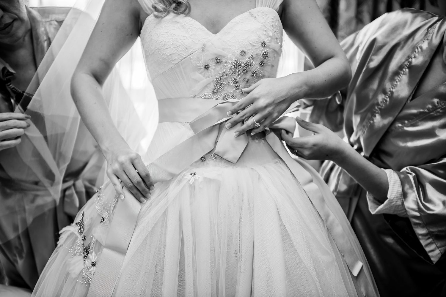 Wedding dress details showing intricate beadwork and fabric texture.