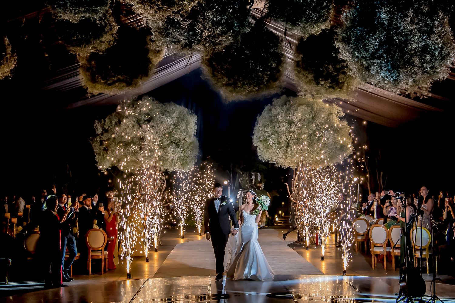 Enchanted garden wedding reception with twinkling lights and floral decorations.