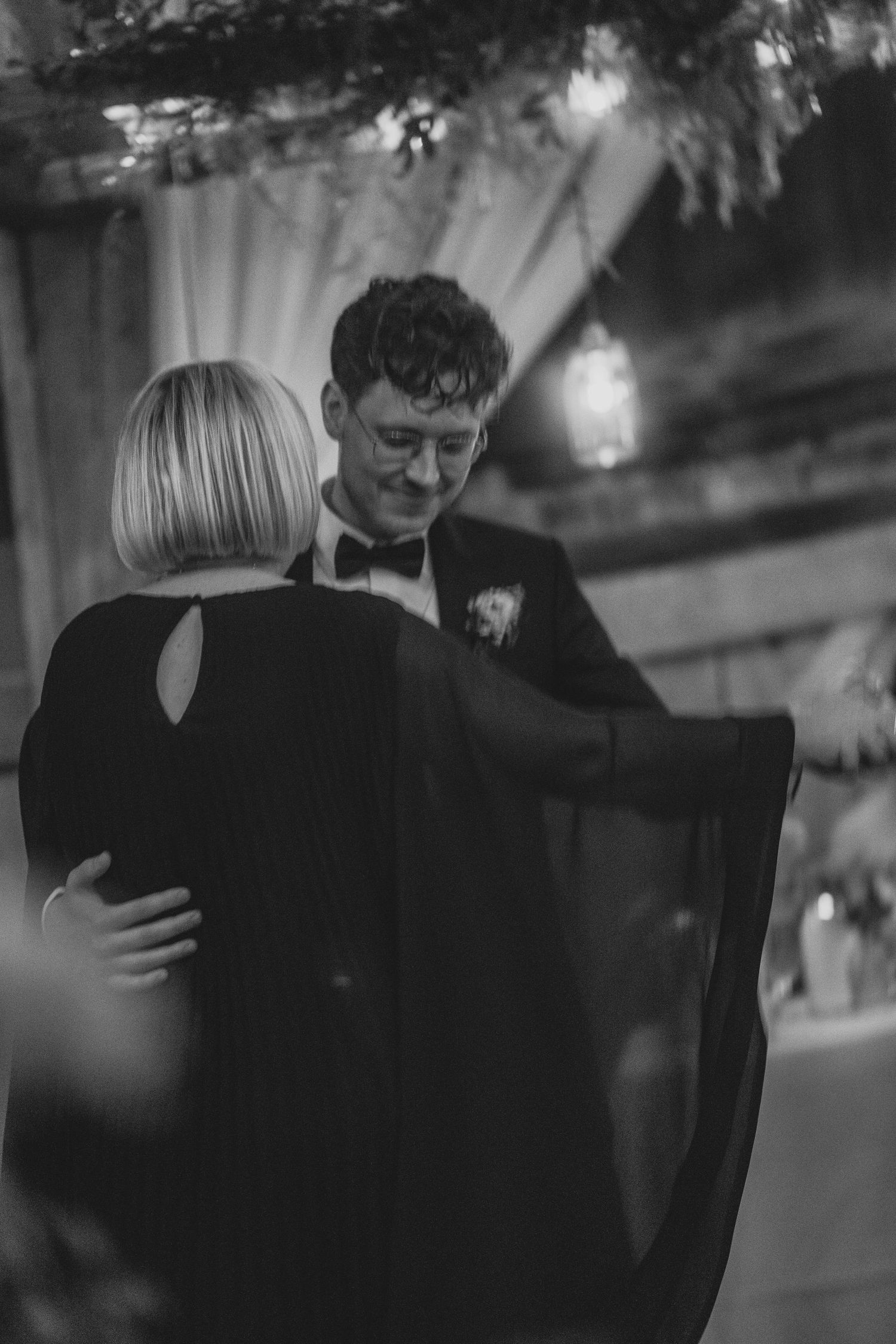 A black and white photo series shows two people dancing together in an intimate embrace.
