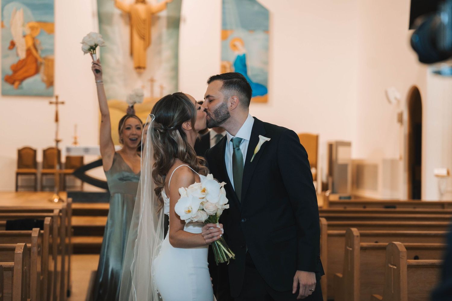 A couple shares an intimate moment during their wedding ceremony in a traditional church setting.