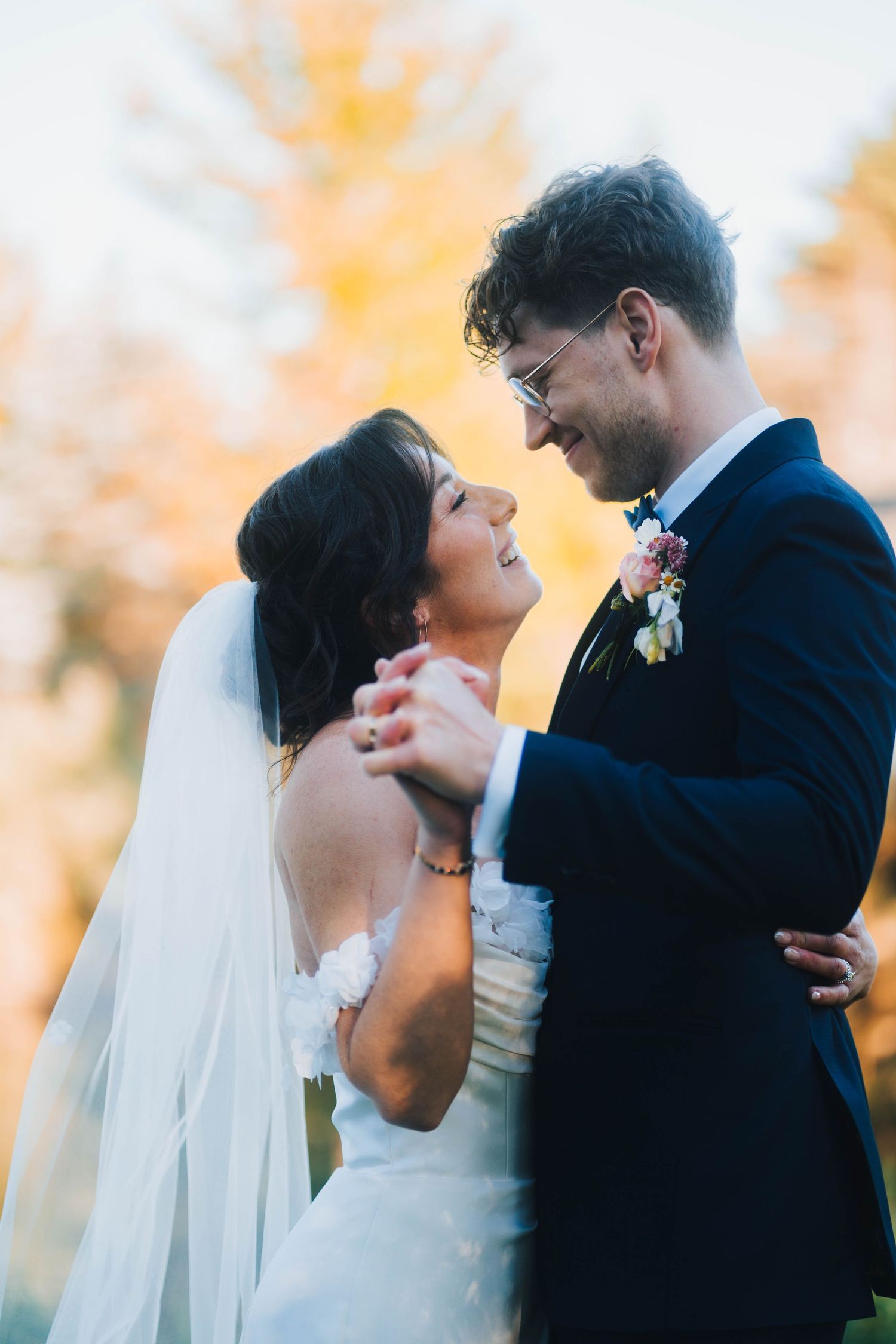 Three romantic wedding photos show tender moments between a bride and groom during sunset with autumn colors in background.