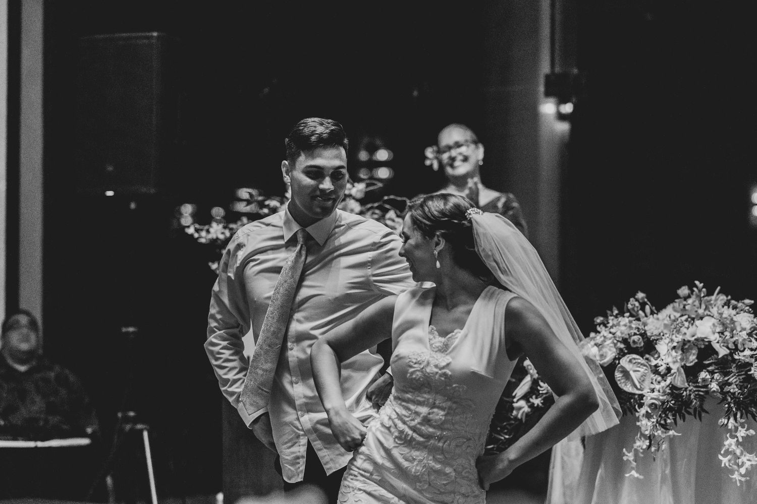 A black and white wedding photo collage showing candid moments of celebration and dancing at a reception.
