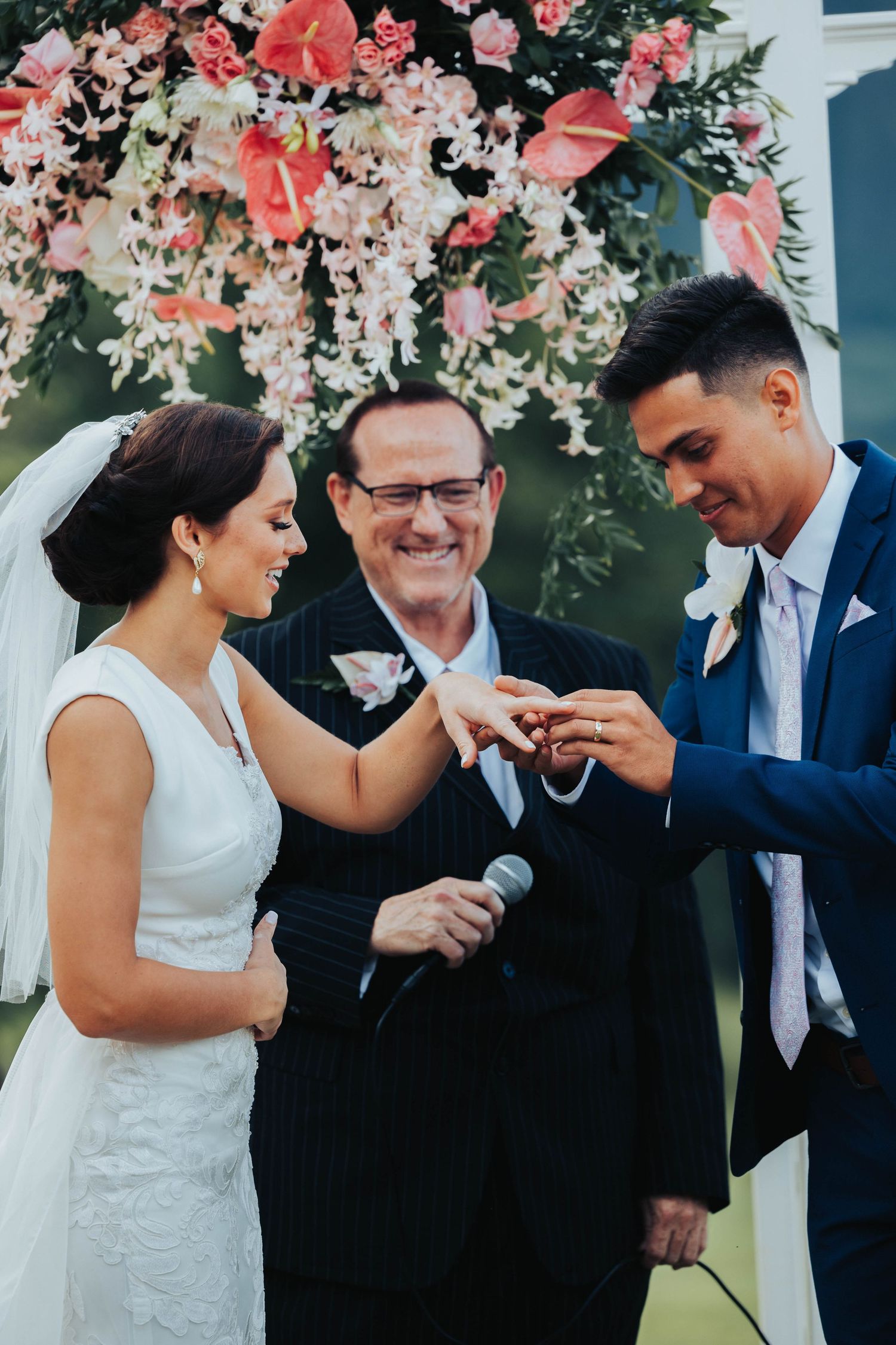 Wedding ceremony sequence showing joyful moments under a floral arch with coral and white blooms.