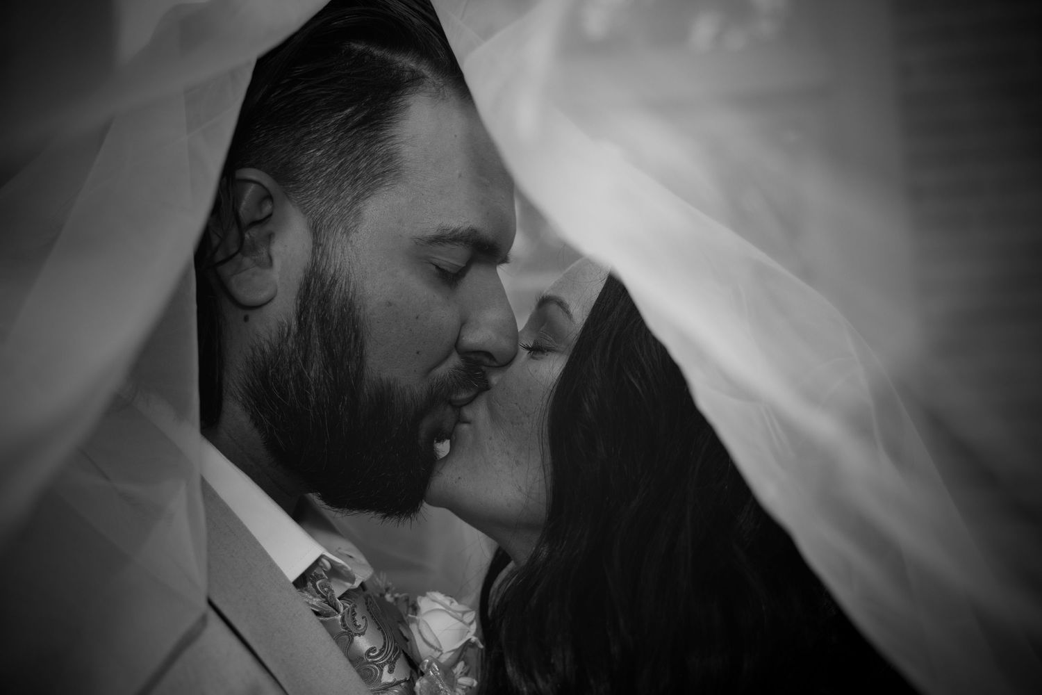 The loving embrace of newly-weds under the veil. Holding a moment forever.
