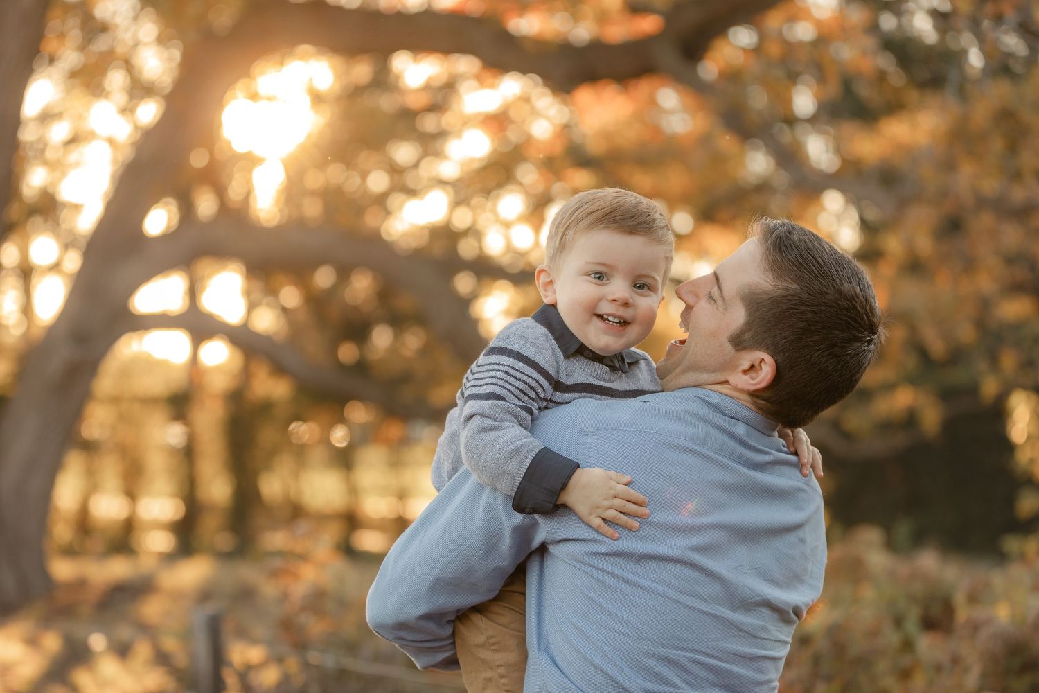 Joyful family interaction captured during golden hour outdoor photography session.