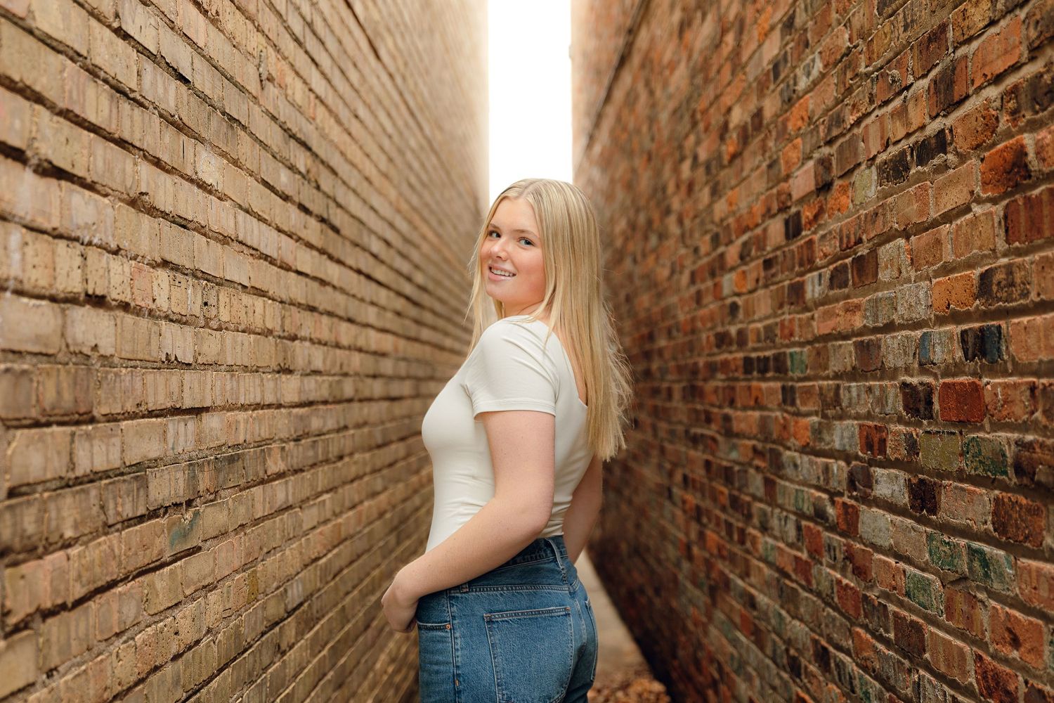 Series of intimate portraits taken in a narrow brick alleyway.