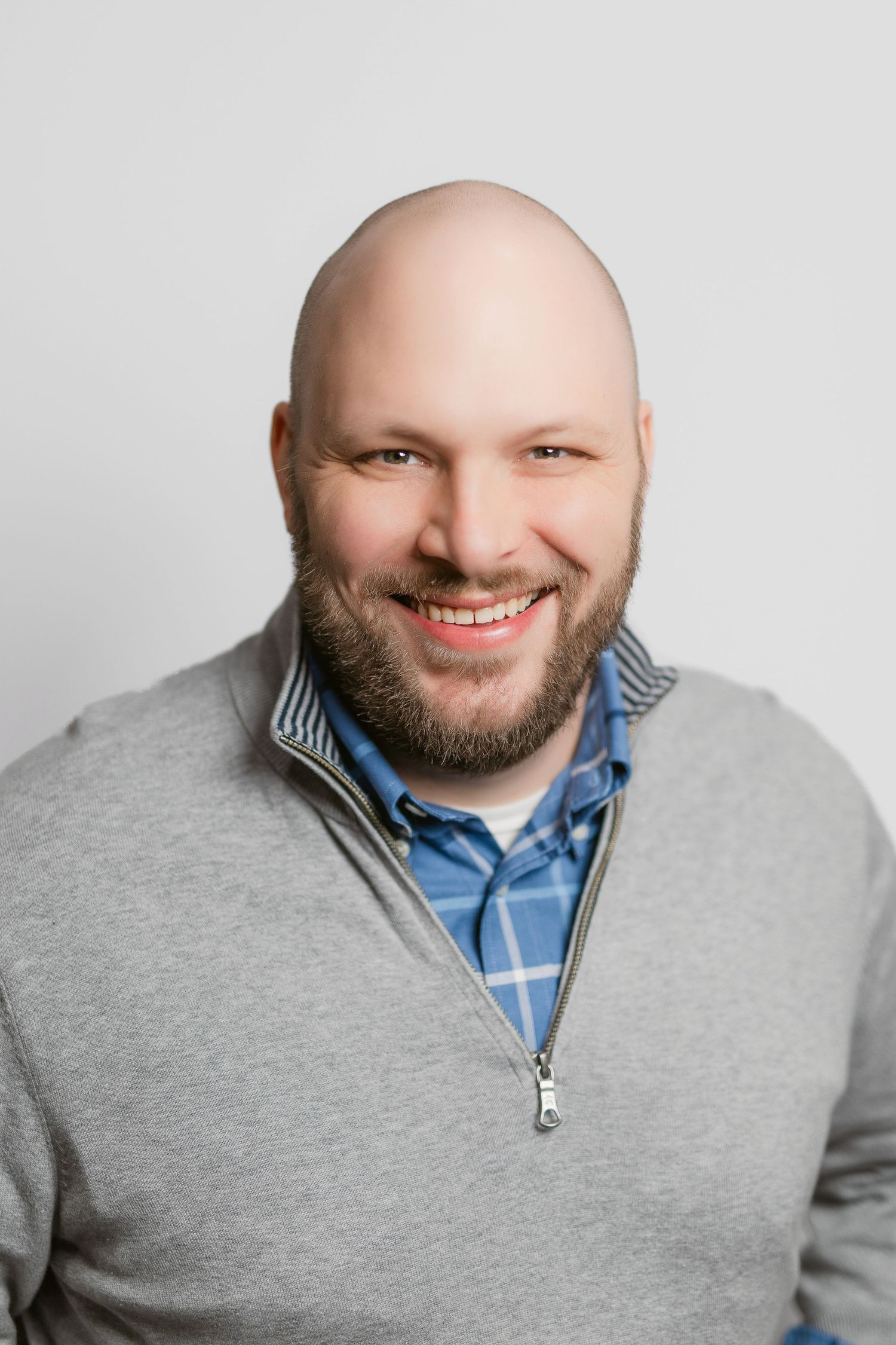 Professional headshots of a person in grey quarter-zip sweater against white background.