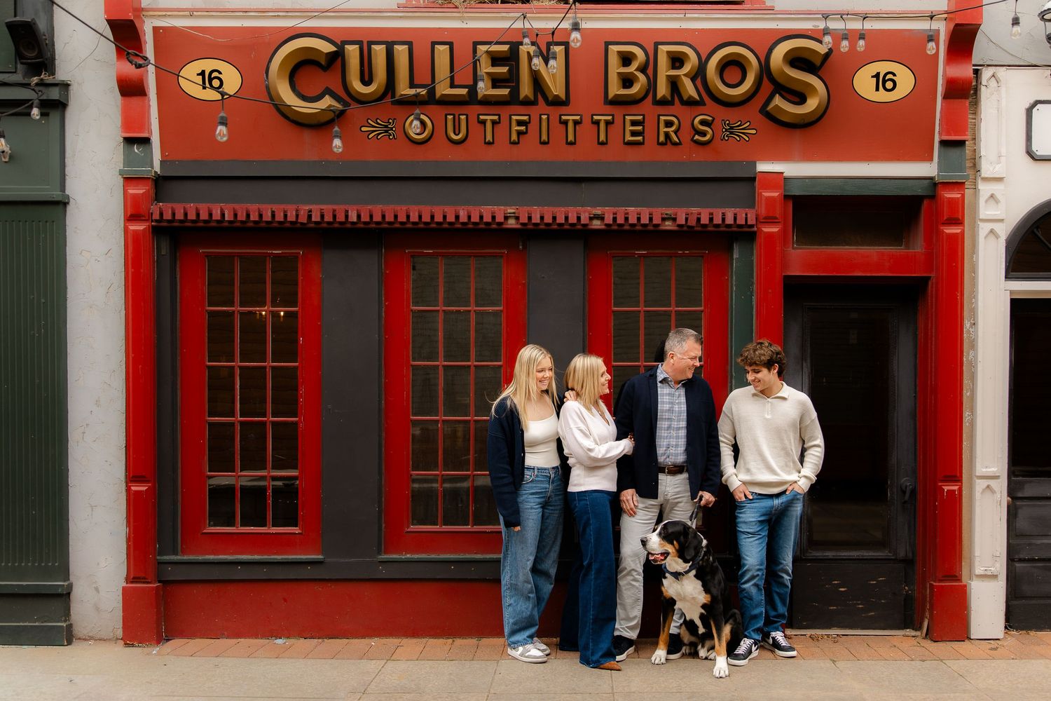 Group photo outside Cullen Bros Outfitters storefront with red trim and signage.