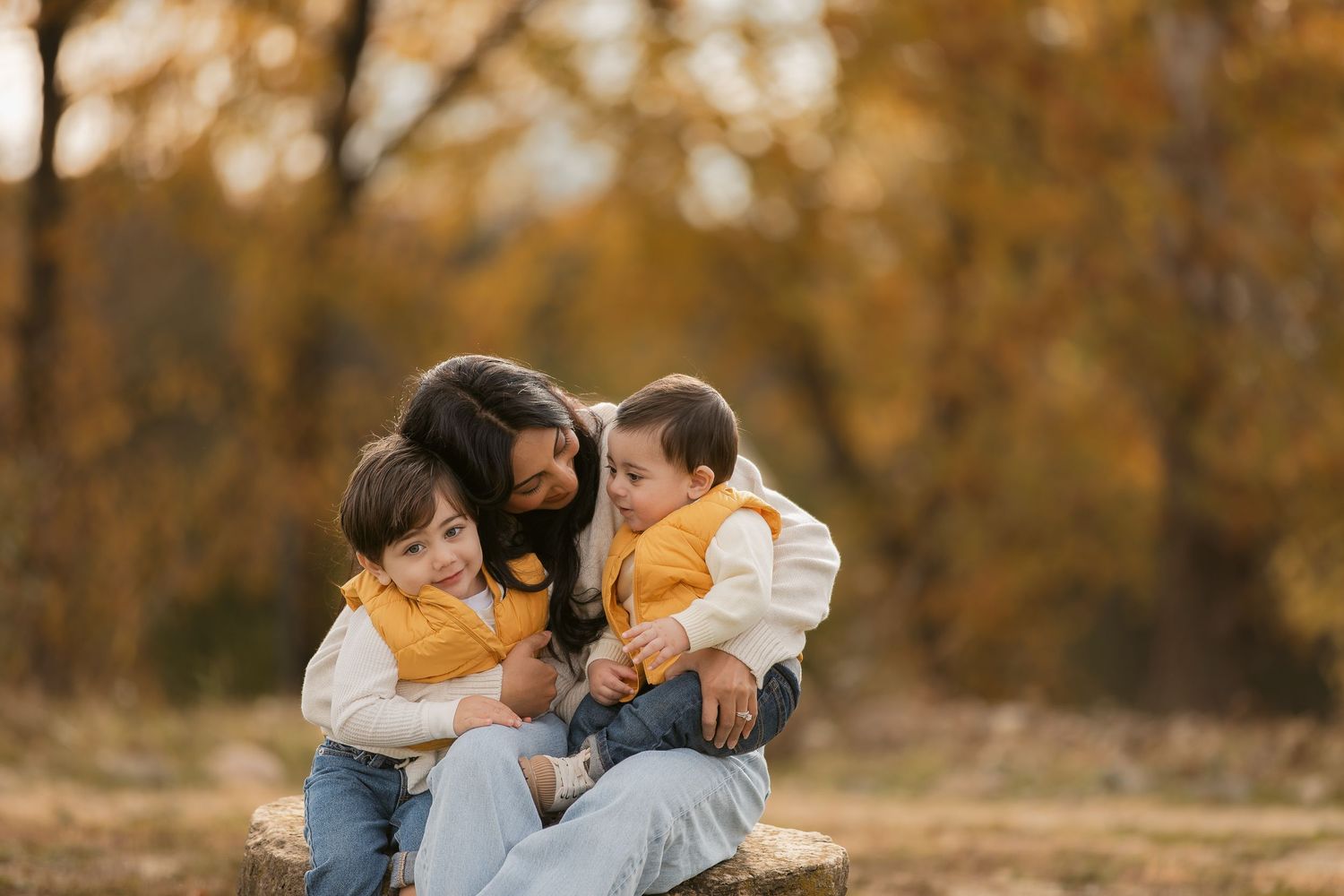 A loving family moment captured outdoors during autumn.
