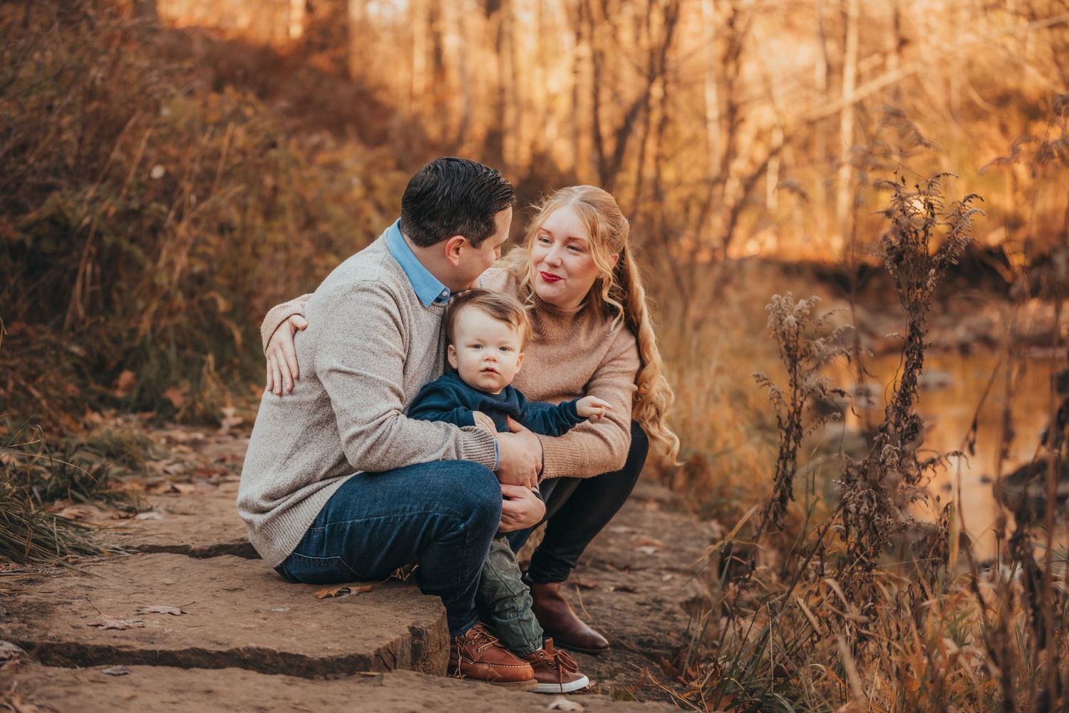 Family sharing intimate moment on nature trail during sunset.