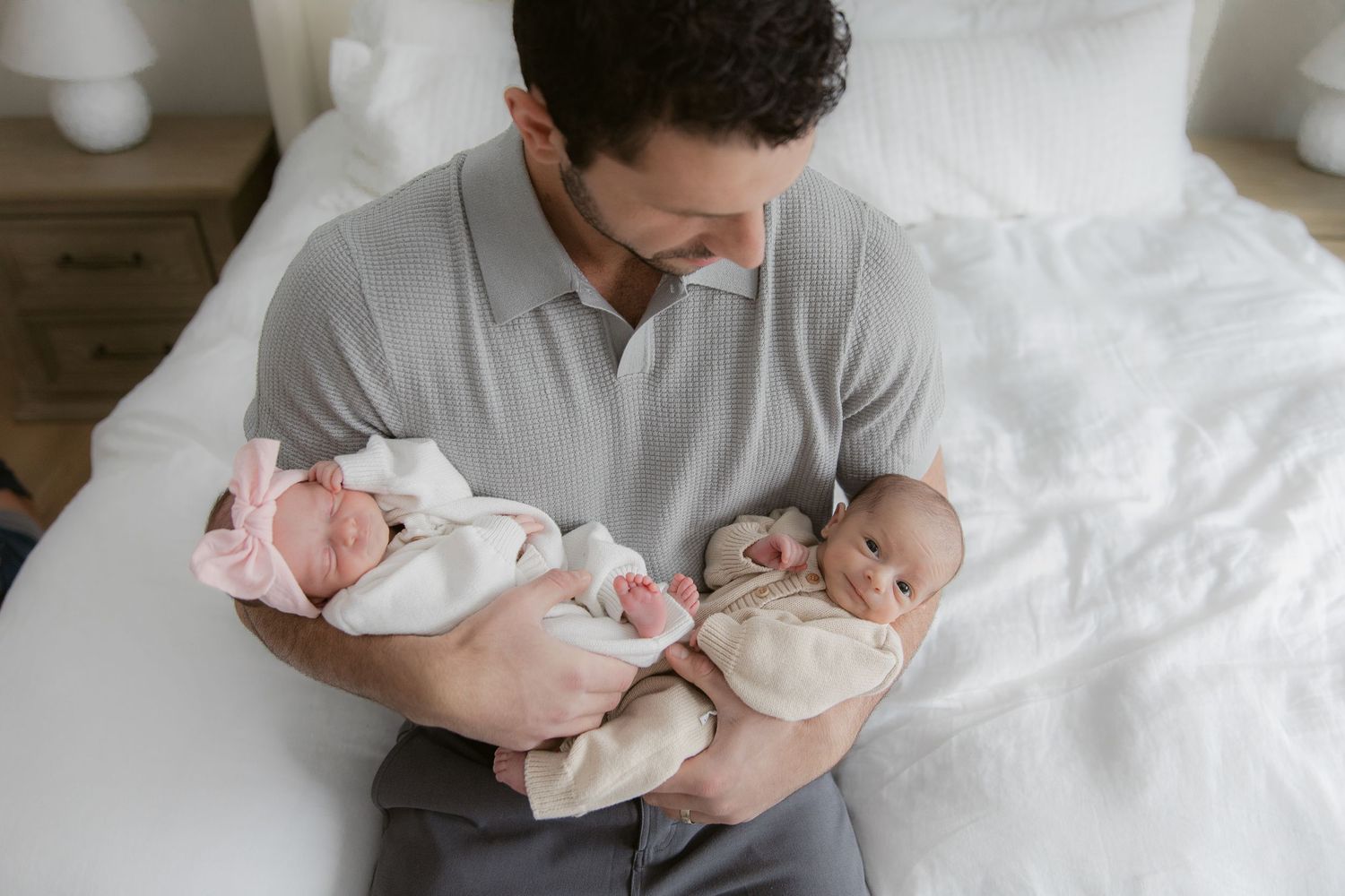 A series of tender moments between parent and newborn baby captured in soft, intimate black and white photographs.