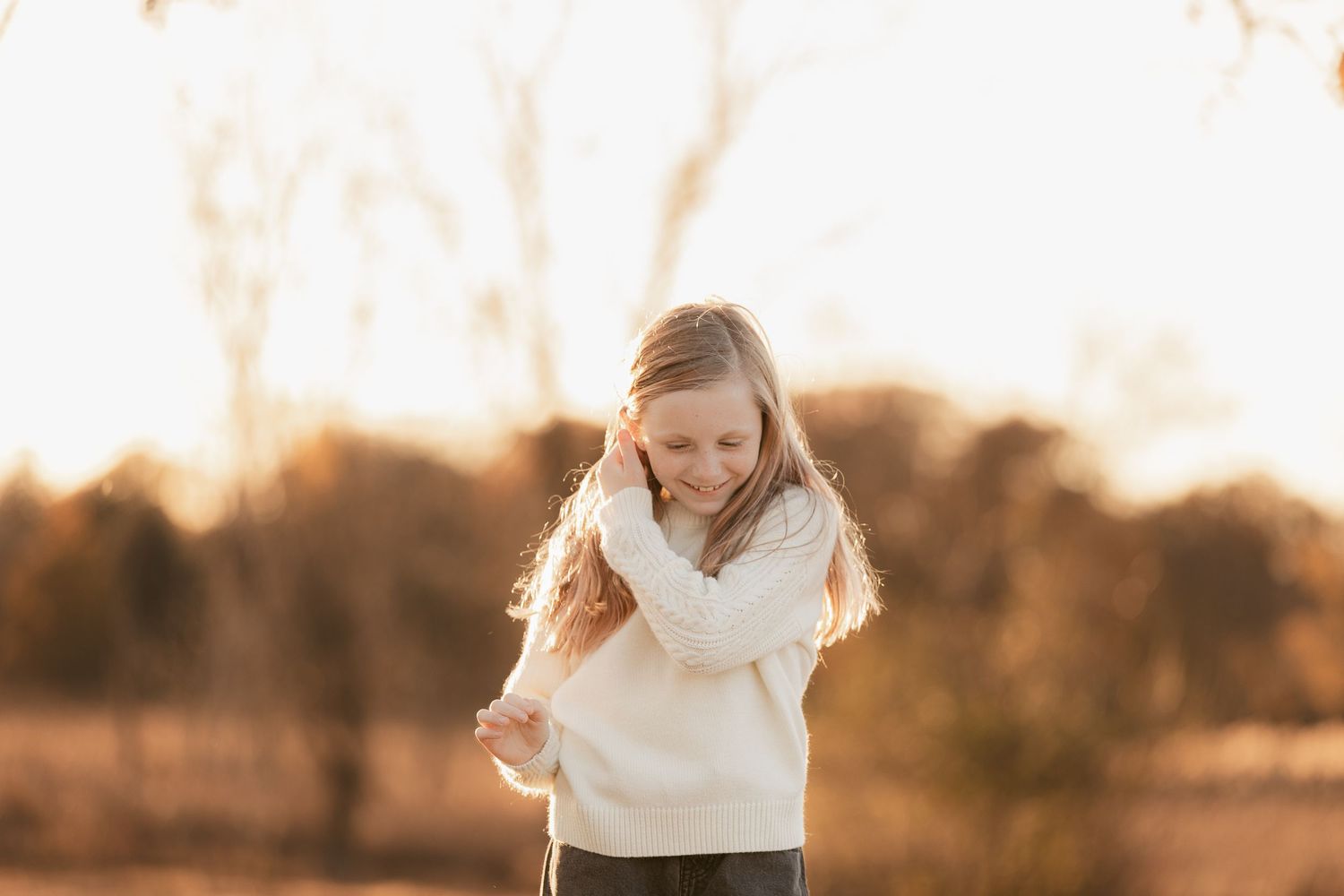 Candid outdoor portrait session in warm sunset lighting.