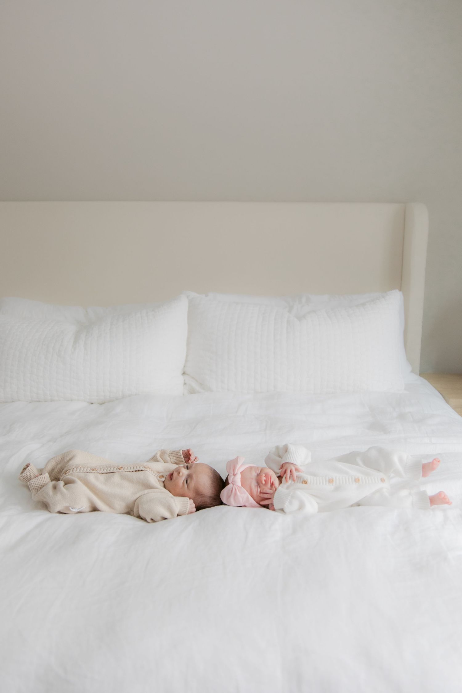 A series of minimalist photographs showing people relaxing on white bedding in a bright bedroom.