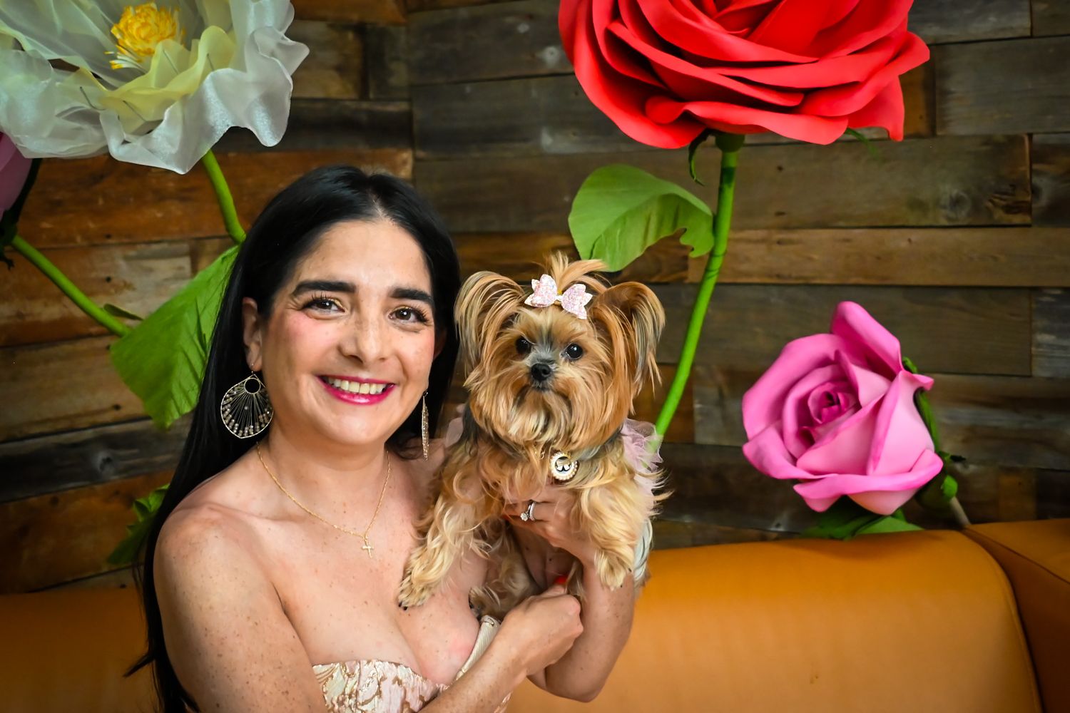 Colorful floral backdrop with large roses decorates a studio setting.