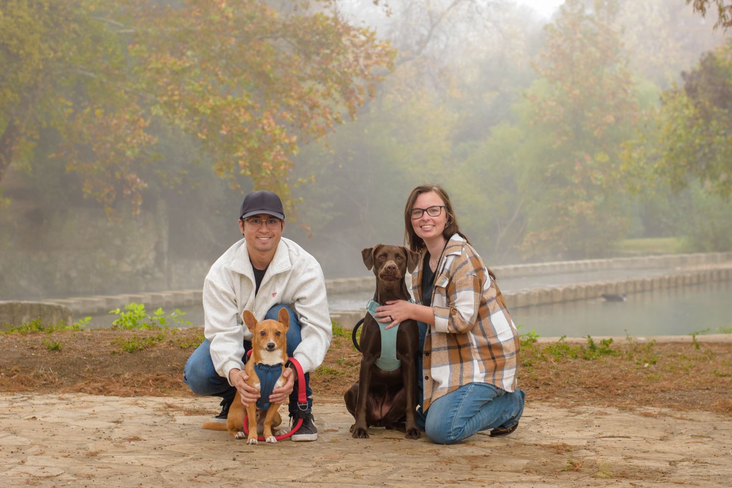 Family photo session with dogs on a misty autumn morning.