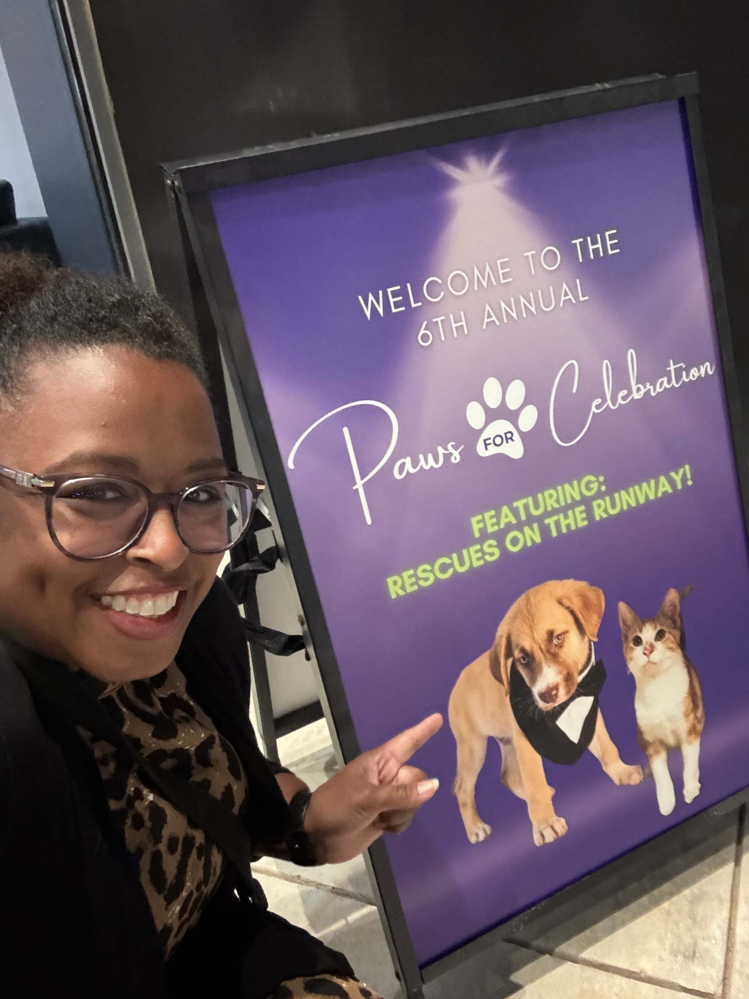 Purple event banner featuring illustrated pets for annual paws celebration.