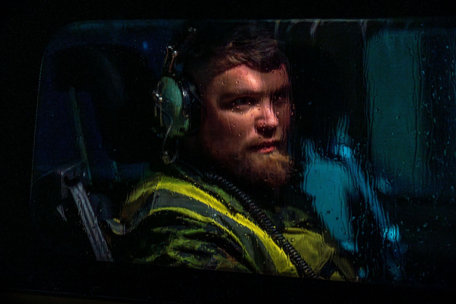 NATO AWACS maintenance crew member seated inside a support vehicle awaiting crew go time.