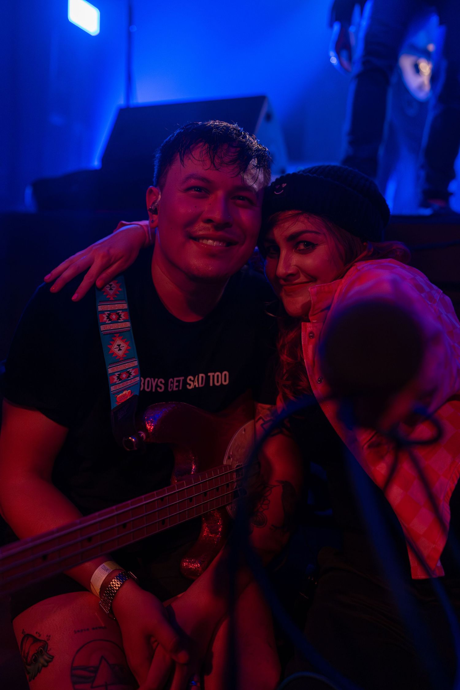 Bass player and lead singer pose mid-show for a photo during the final song of a live show in Belgium.