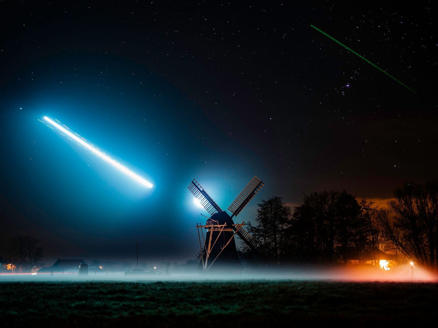 Two F-35 fighter jets approaching a runway for landing at night, captured with a slow shutter effect.