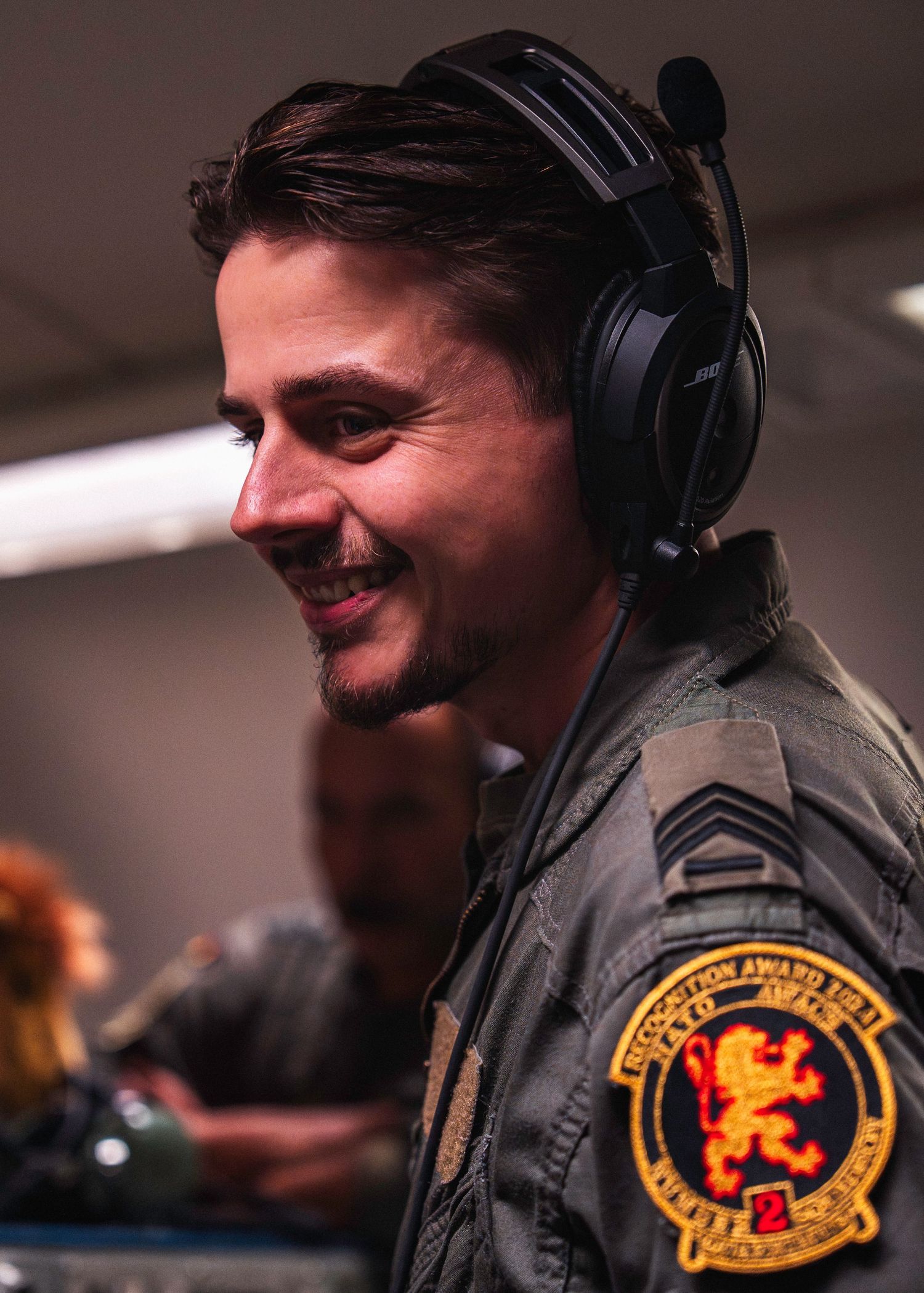 NATO AWACS crew member wearing a headset during mission operations.