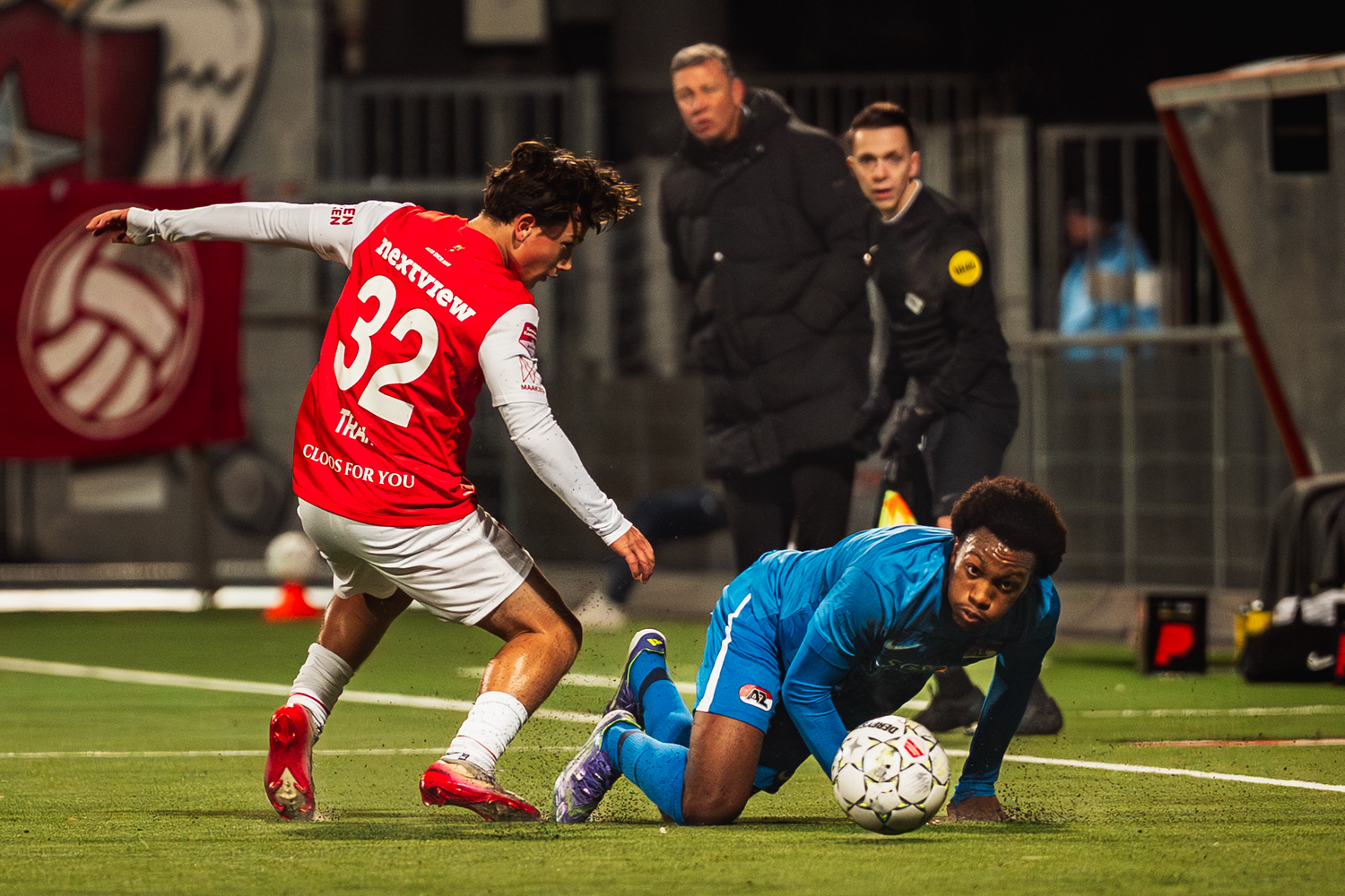 Soccer players compete for possession of the ball during an intense match on the field.