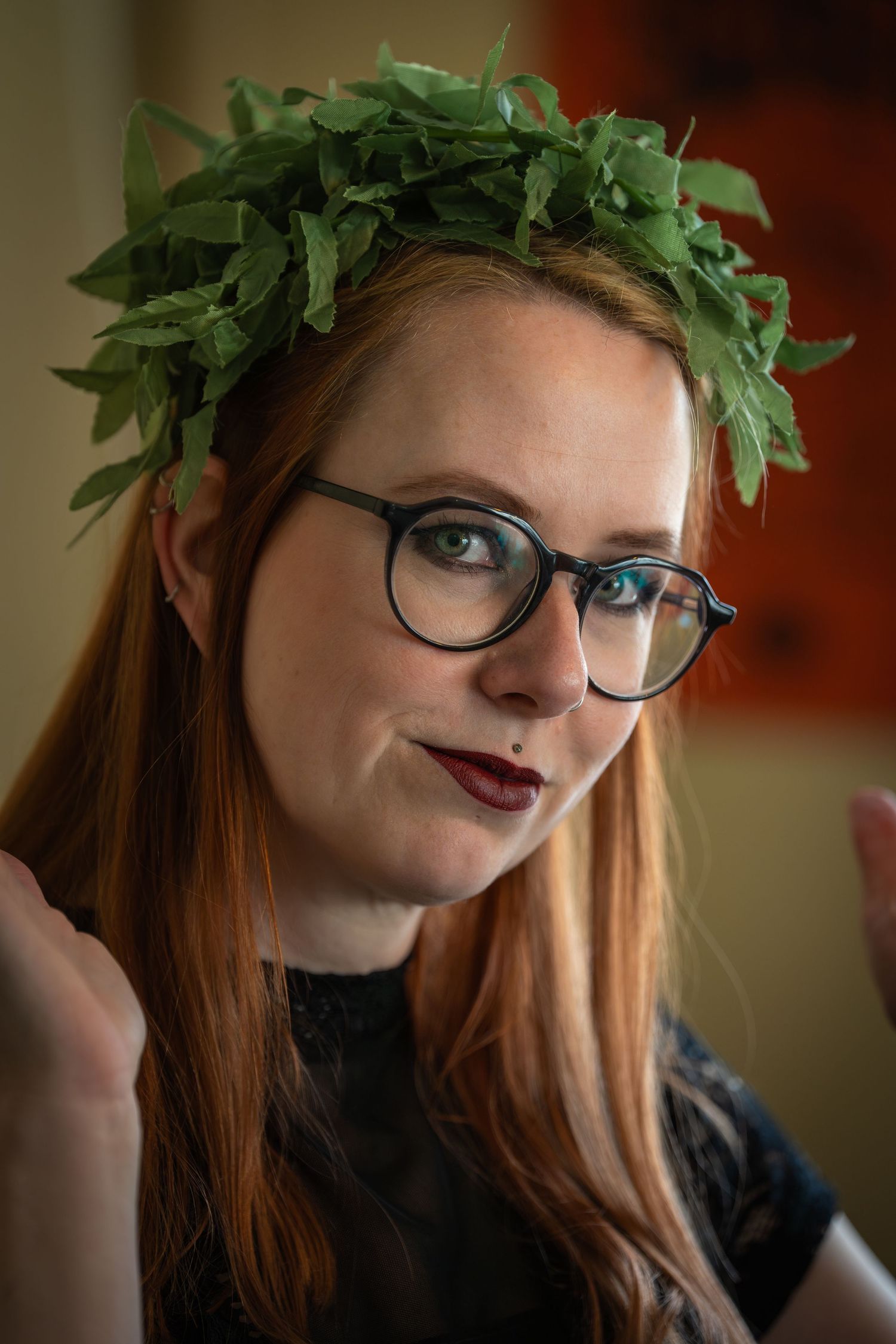 Portrait of a woman wearing glasses, photographed for a tattoo shop.
