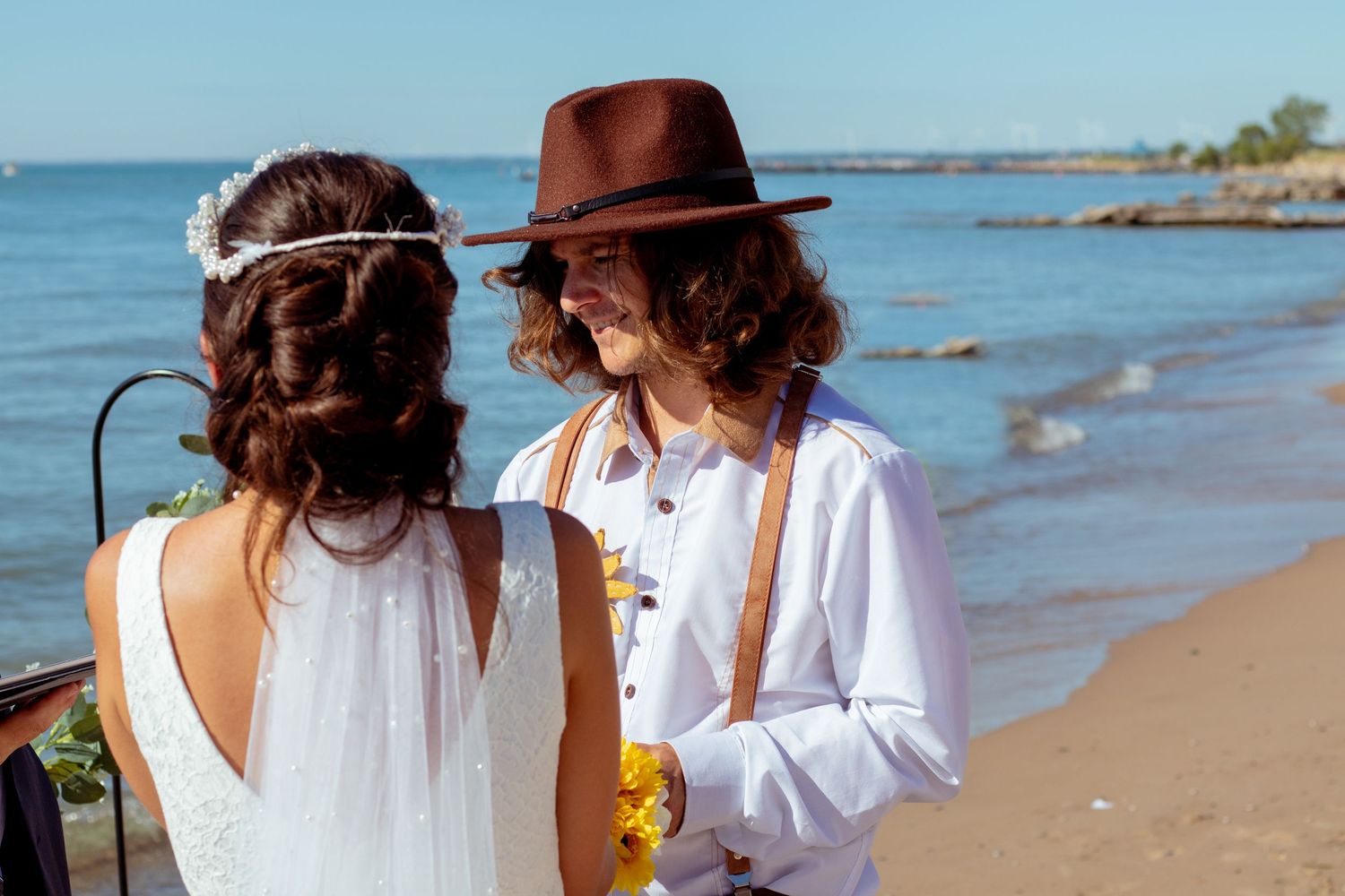 bride and groom holding hard with a lake view at kitchener–Waterloo Cambridge Region