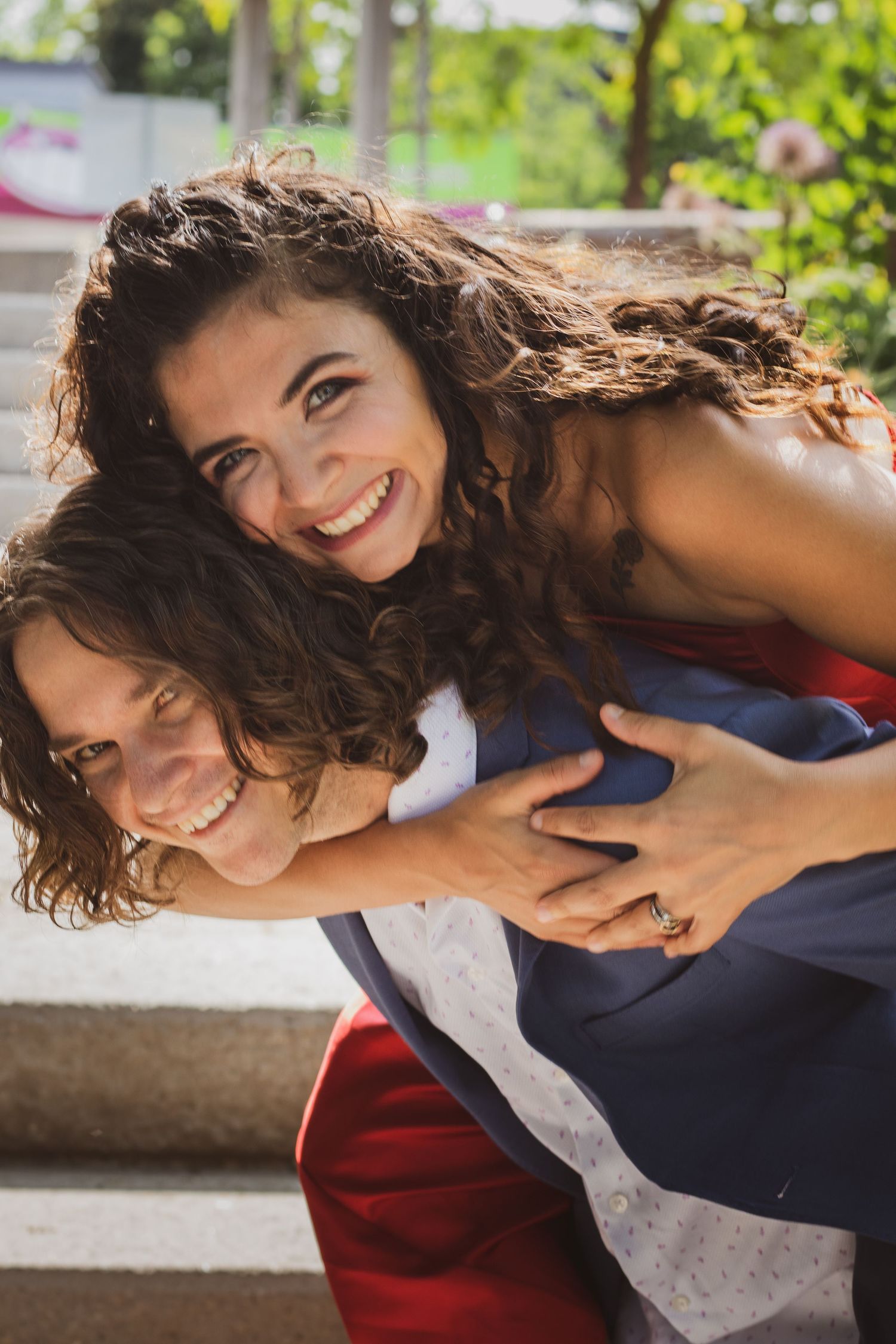 bride jumping on groom's back sharing a smile in the Kitchener-Waterloo region