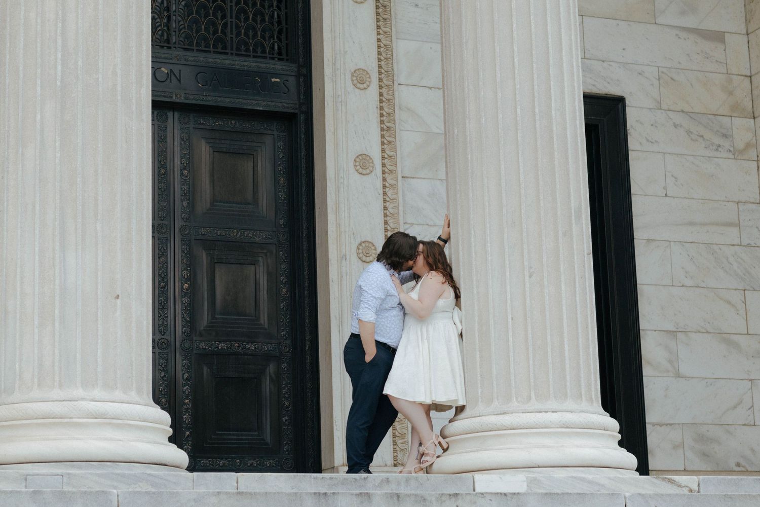 White marble columns frame an elegant architectural entrance.