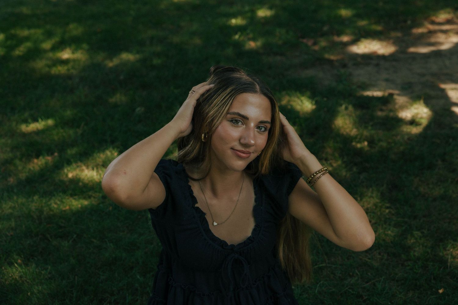 Artistic outdoor portrait session in a shaded natural setting.