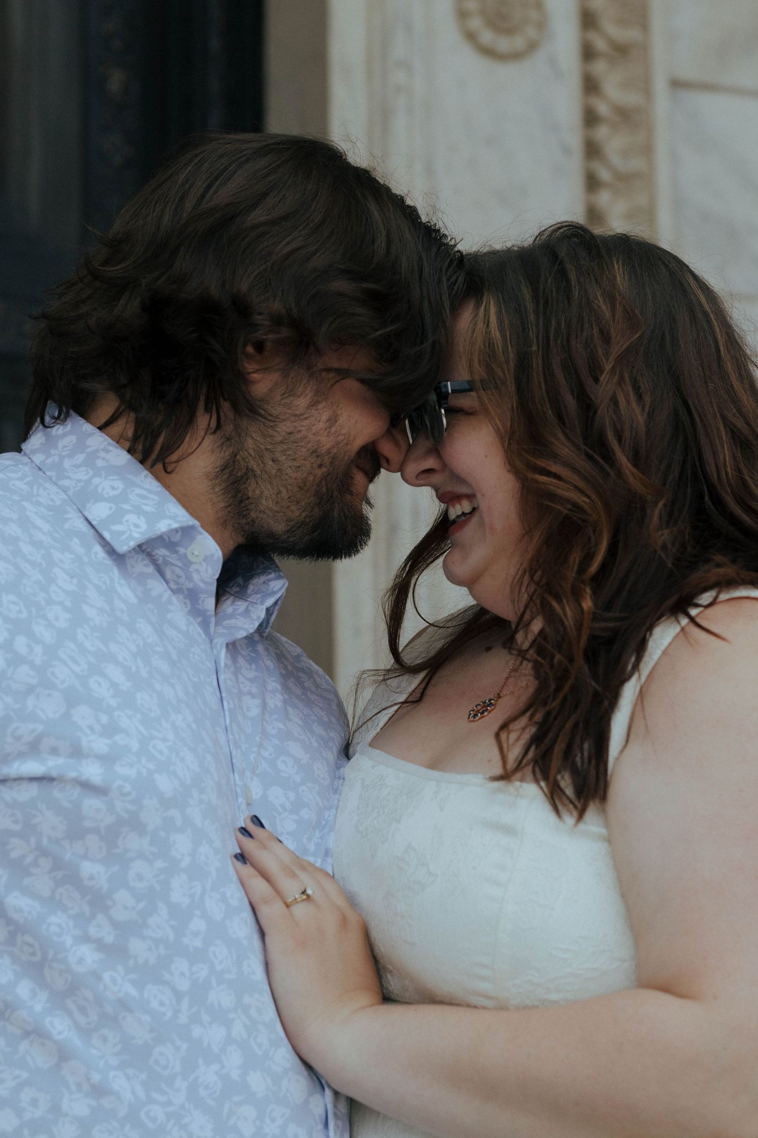 A tender romantic moment between a couple in wedding attire sharing an intimate embrace.