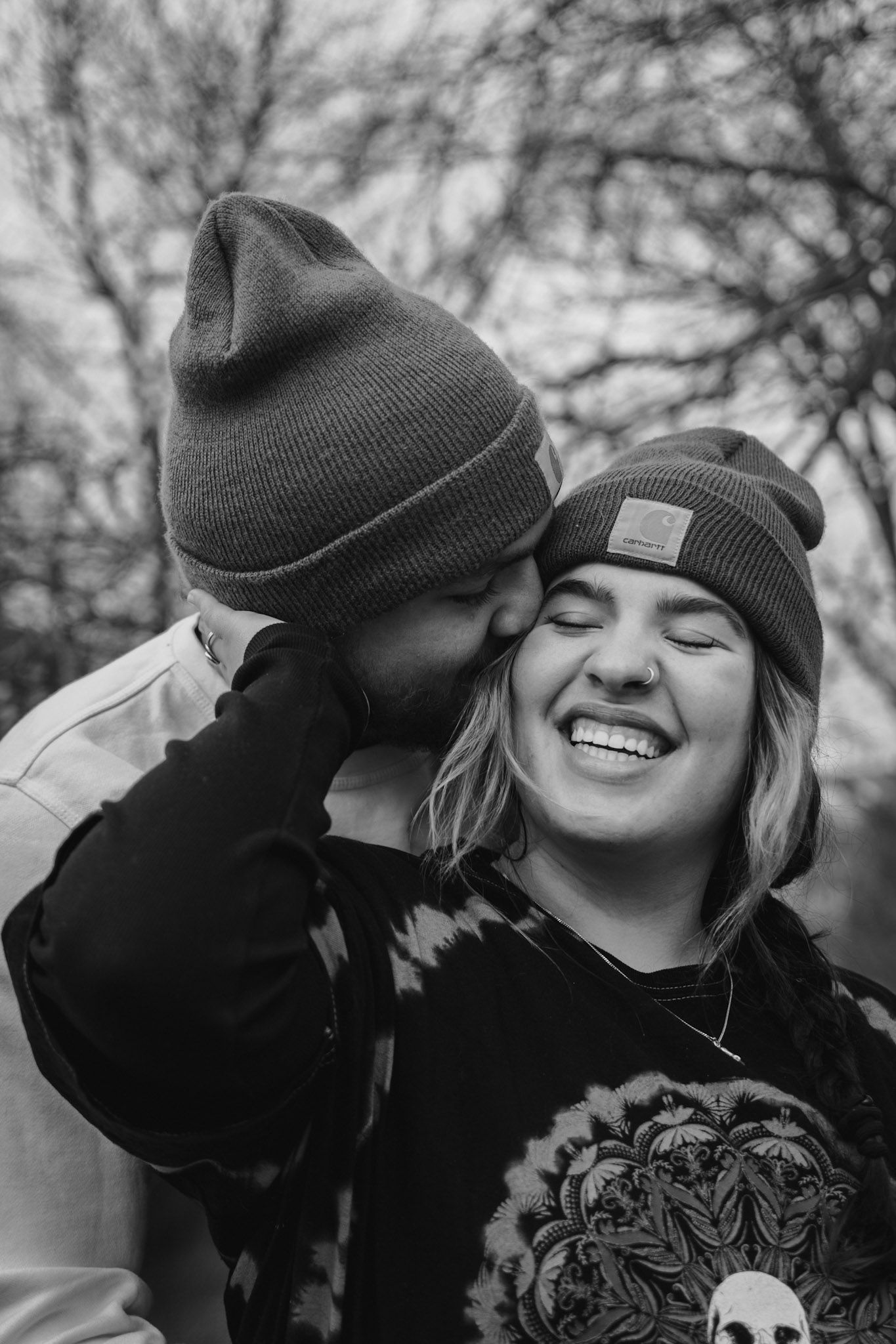 Candid black and white couple portrait at White Lady’s Castle in Durand Eastman Park, Rochester NY, featuring rustic textures winter fashion