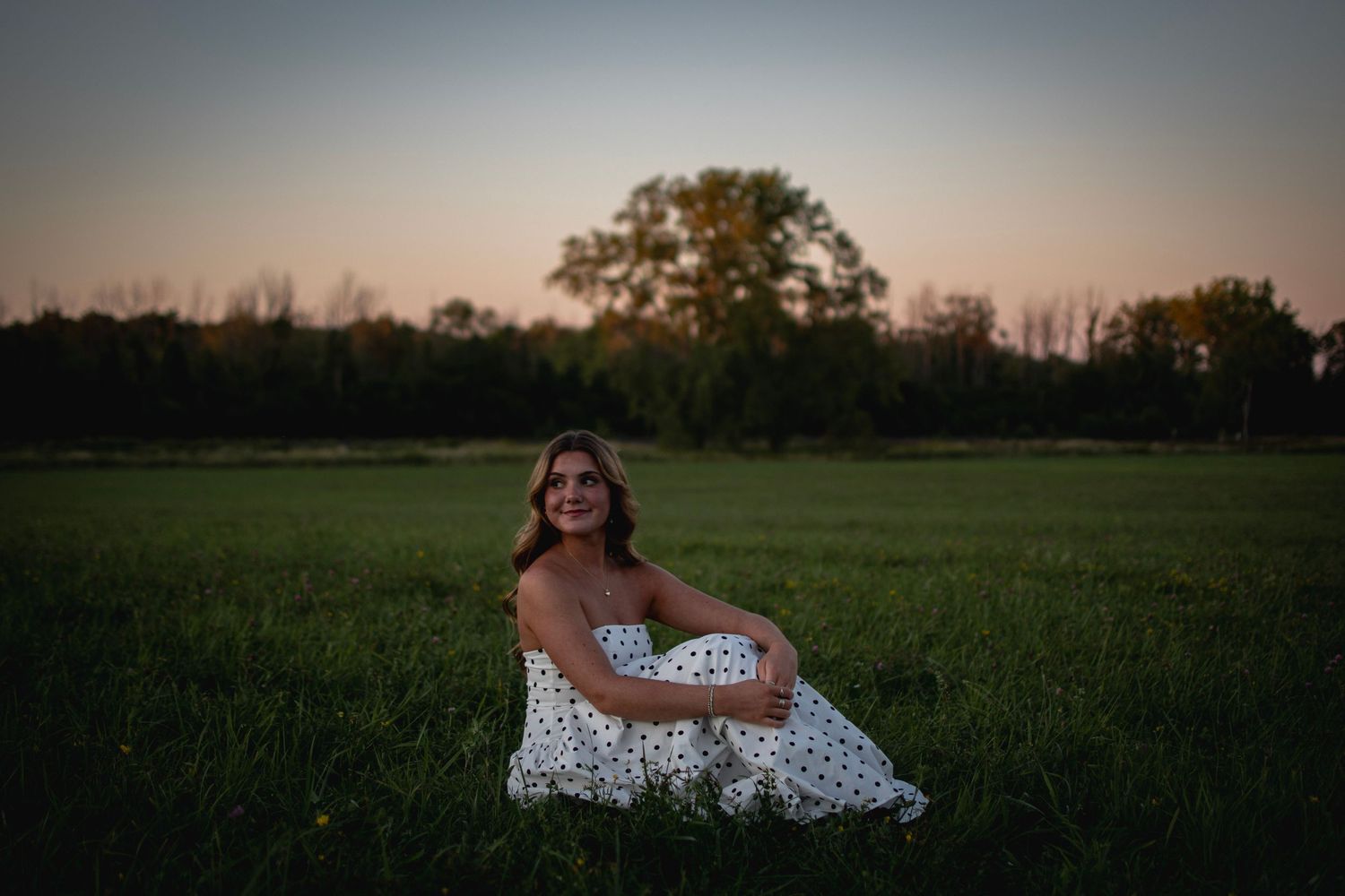 Moody fall senior portrait of teenager in white dress, back-lit by sunset in Warners NY (Syracuse NY).