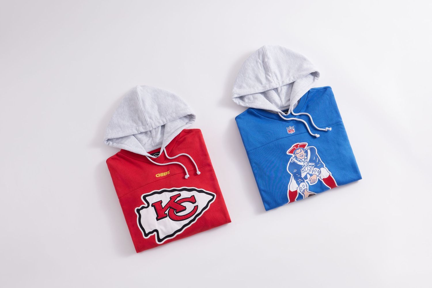 NFL team hooded sweatshirts in red and blue colors arranged in a row on white background.