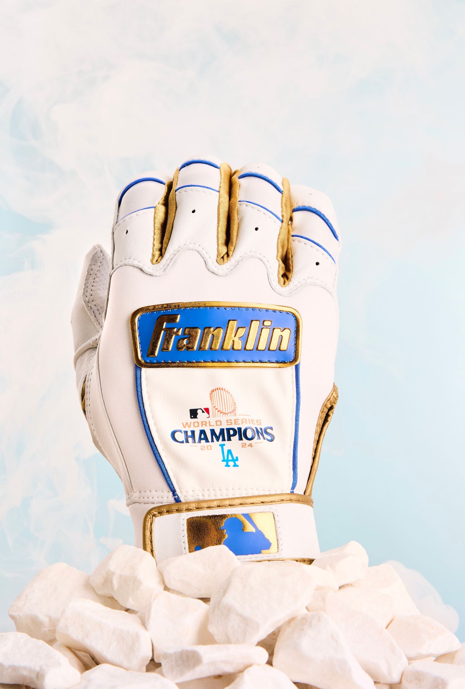 A white Franklin MLB Champions baseball batting glove with blue accents and LA Dodgers logo against a light background.