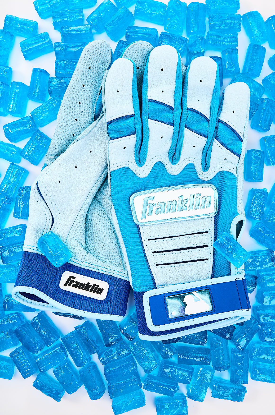 Franklin Sports baseball batting gloves arranged on a white background with blue candy.