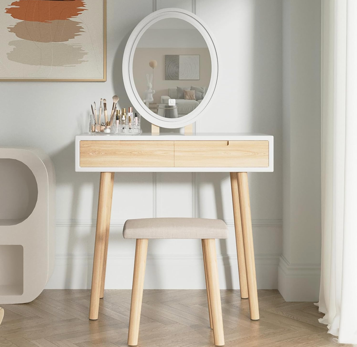 Modern white and natural wood vanity dressing table set with oval mirror, two drawers, and padded stool.