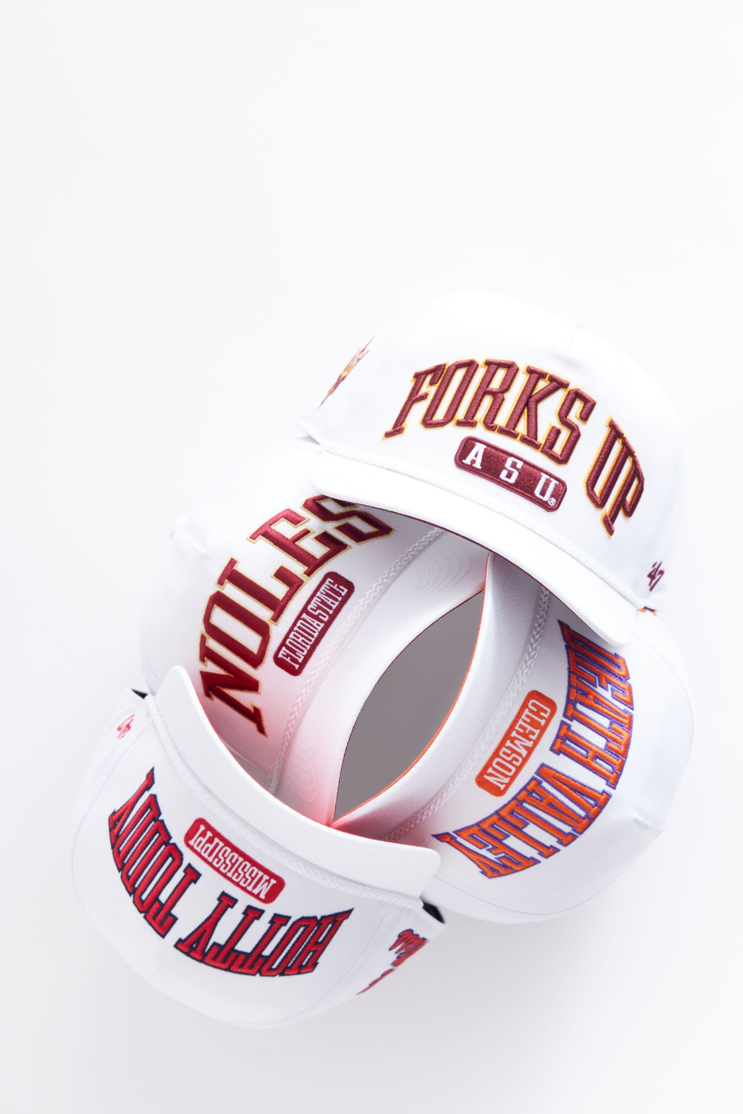 A series of white paper rings with red text arranged in a curved line showing a typographic design pattern.