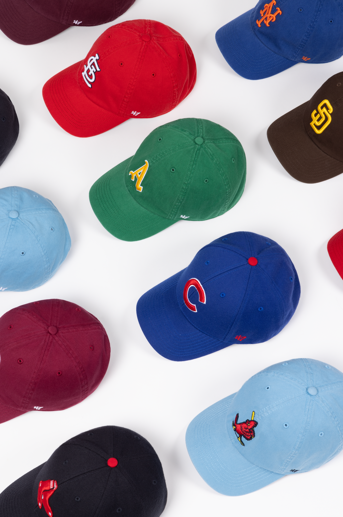 A collection of colorful baseball caps with various team logos arranged in a grid pattern against a white background.