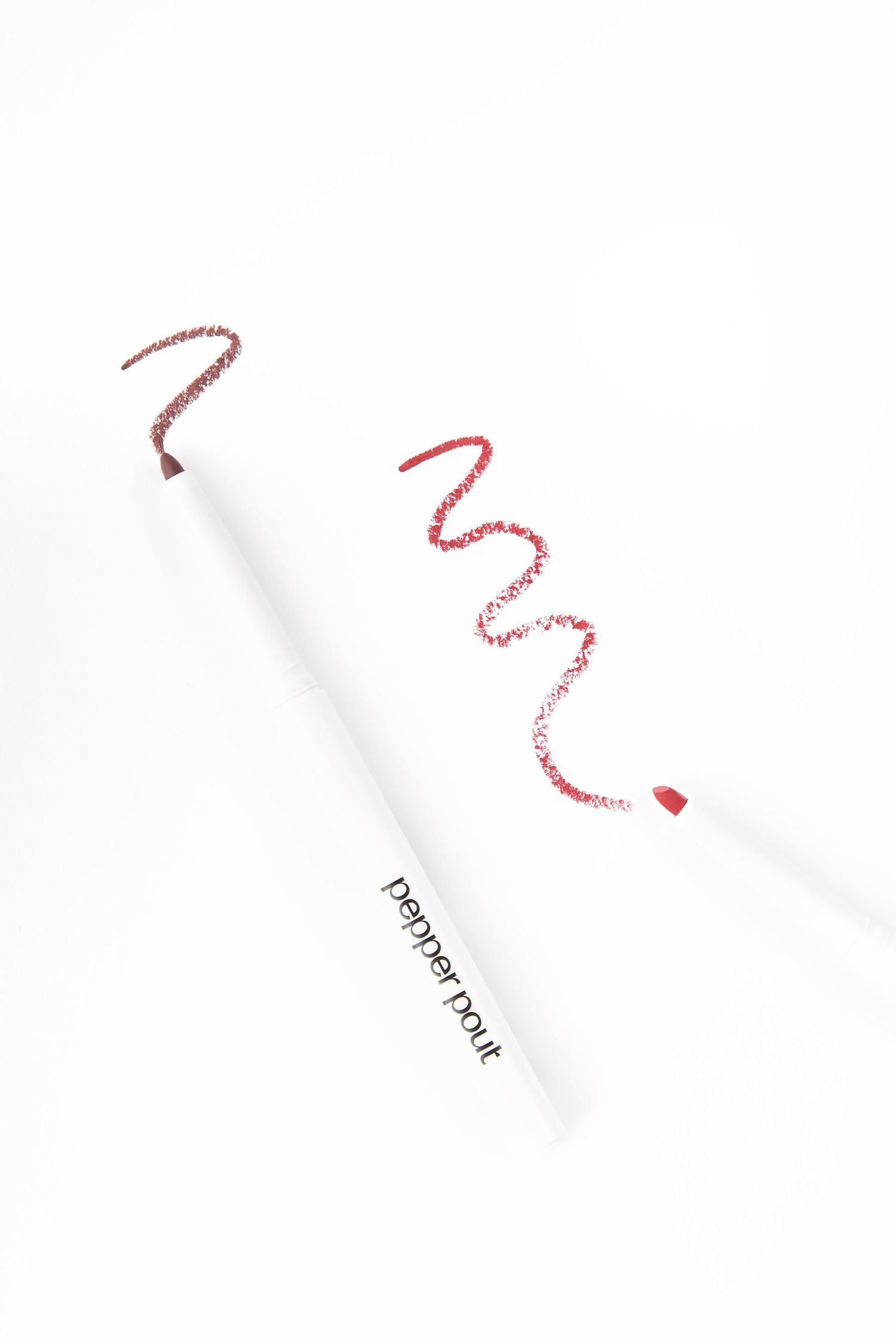 Pepper Pout white lip liner pencil with red shade swatch on white background.