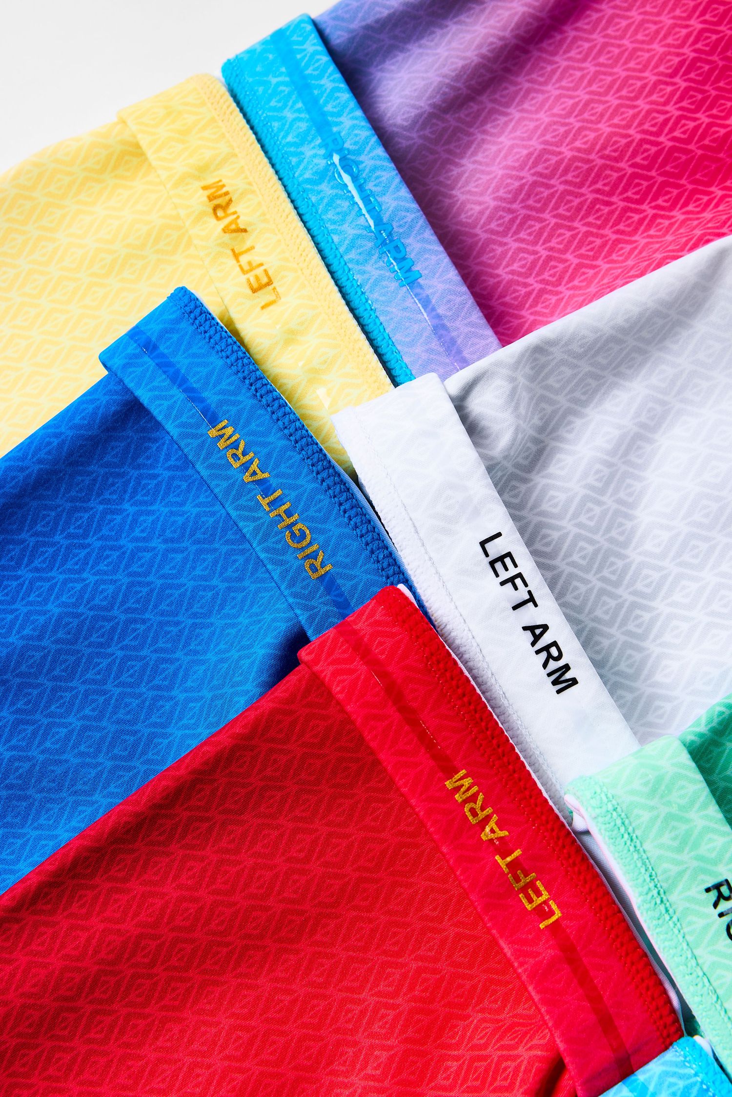 Colorful fabric swatches arranged in a diagonal pattern showing vibrant blue, red, pink, yellow and white textiles.