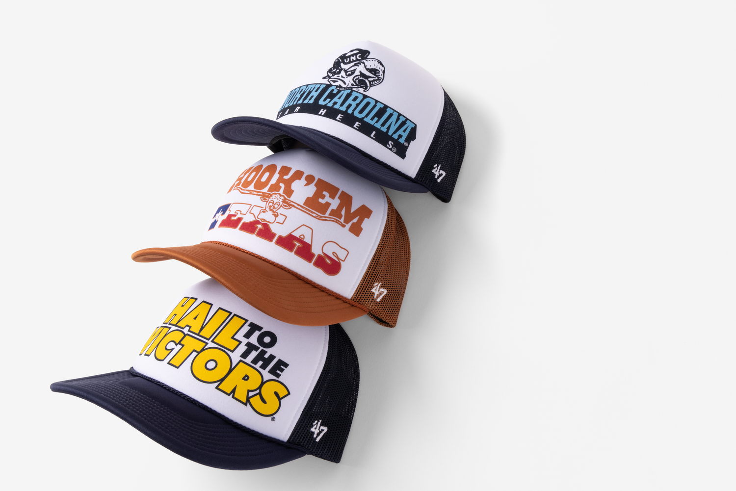 Three vintage-style trucker caps with different logos and designs stacked on a white background.
