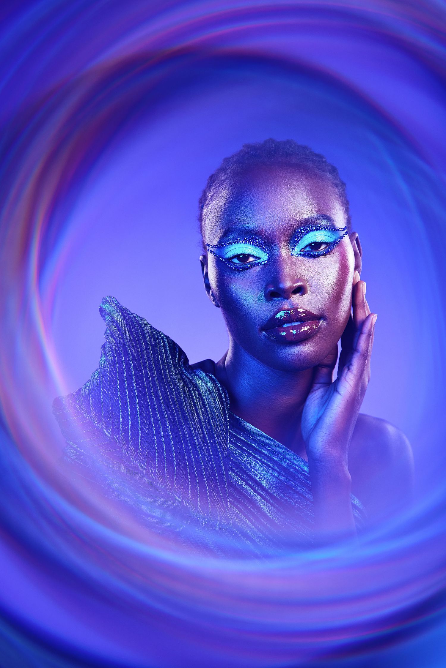 Artistic portrait series in vibrant blue lighting with swirling effects creating a dreamy, ethereal atmosphere.