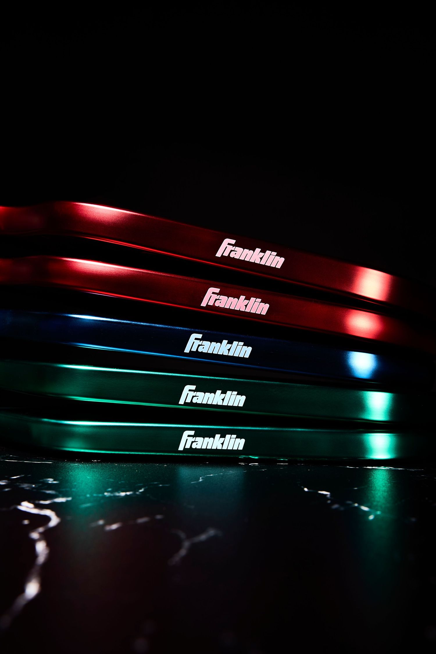 Franklin logo illuminated with dramatic red and teal lighting effects against a dark background.