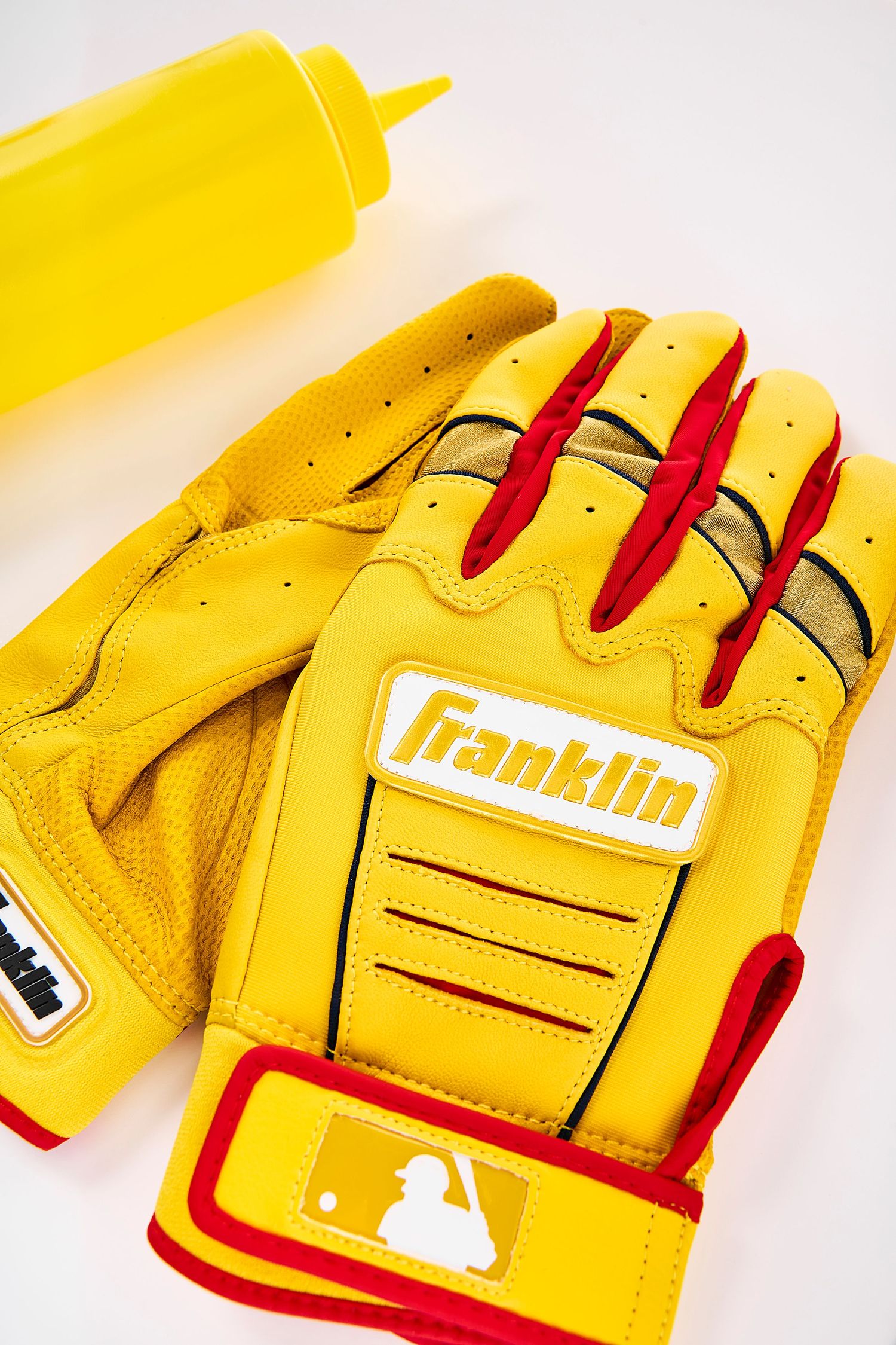 Close-up sequence showing details of a yellow and red Franklin baseball glove from different angles.