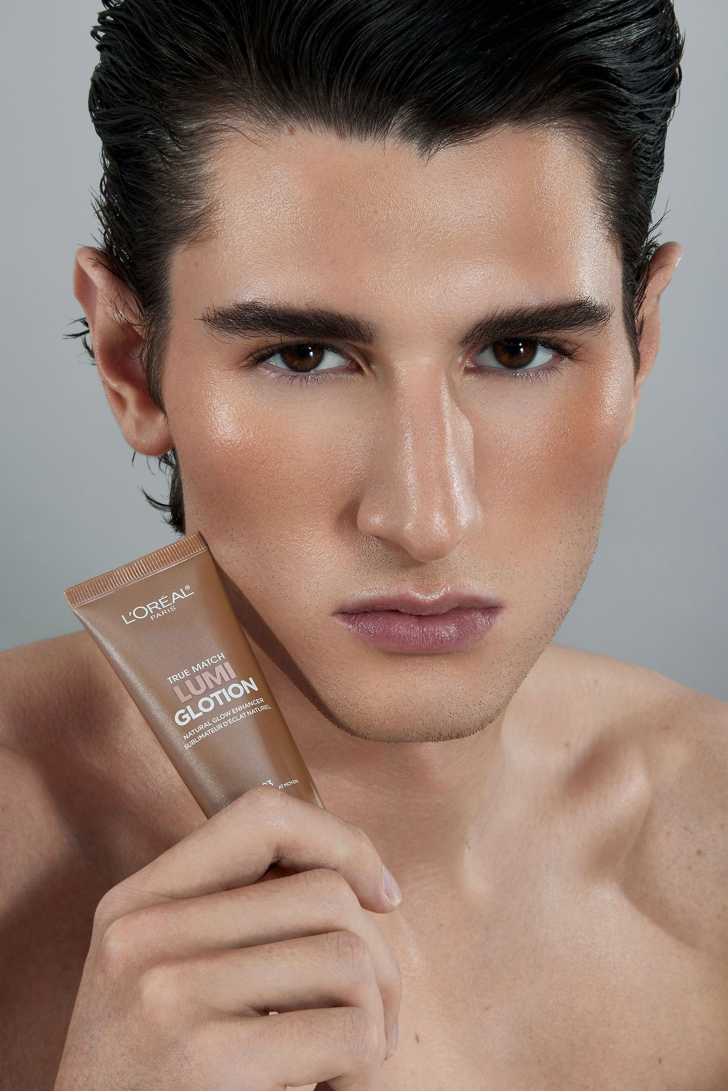 Beauty advertisement showing close-up shots of model holding makeup product against bare shoulders in studio lighting.