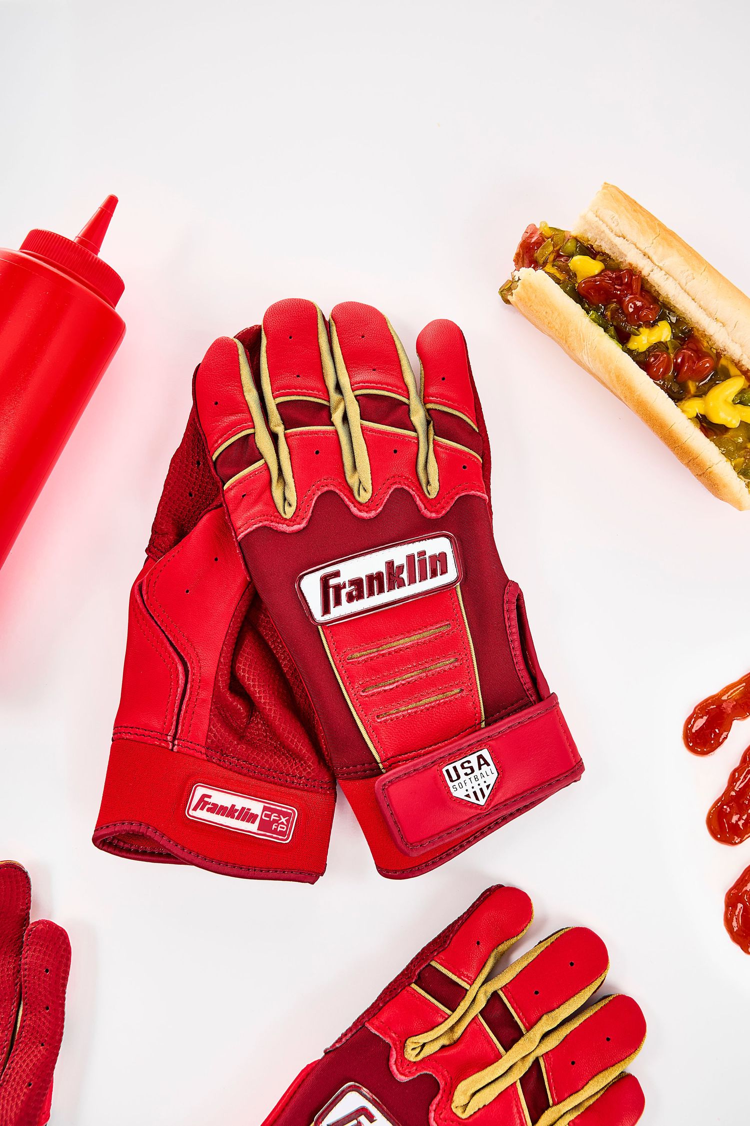 Red Franklin sports gloves with yellow accents displayed against a white background.