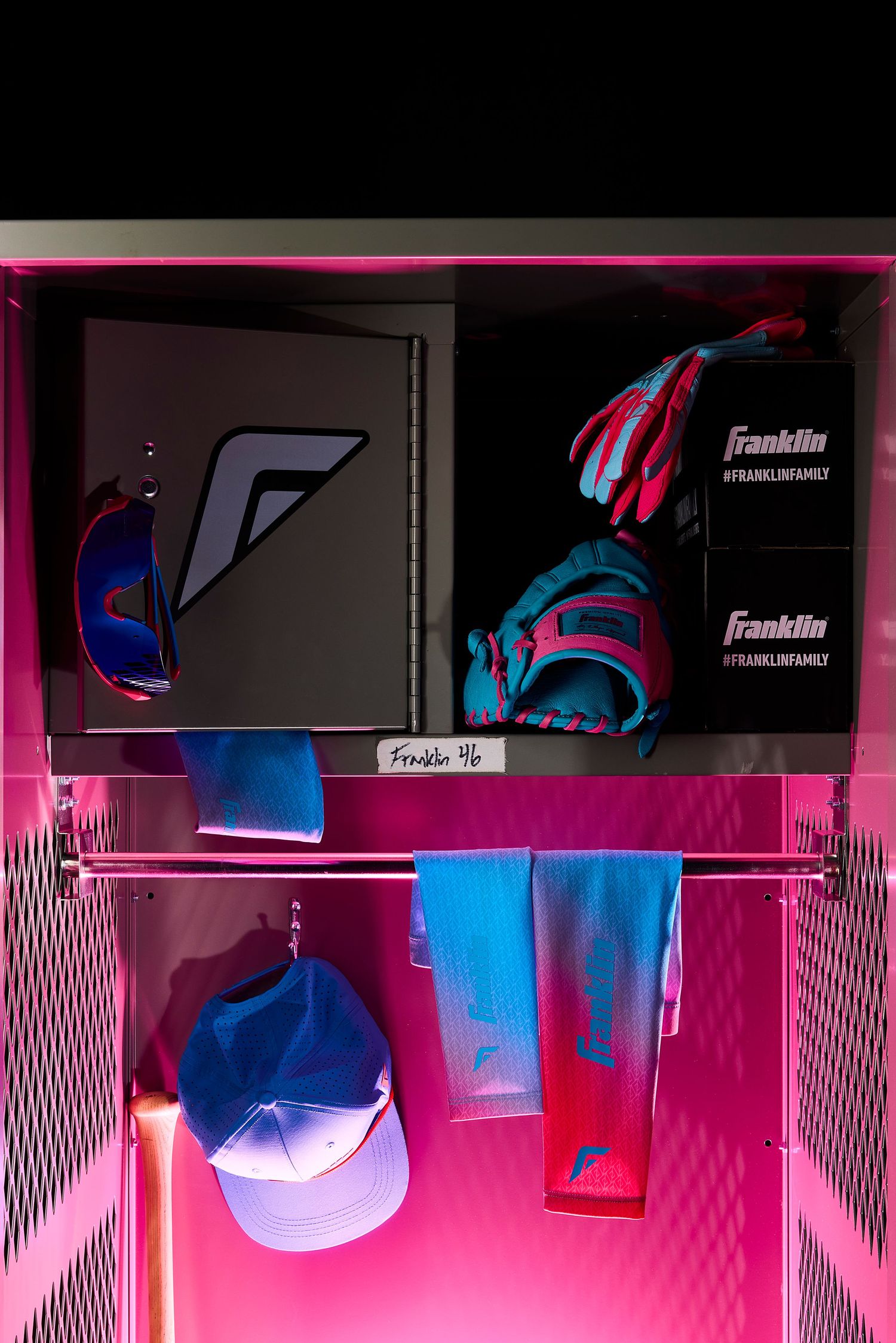 Neon pink and blue lighting illuminates a row of sports equipment and gear displayed on shelves in a retail setting.