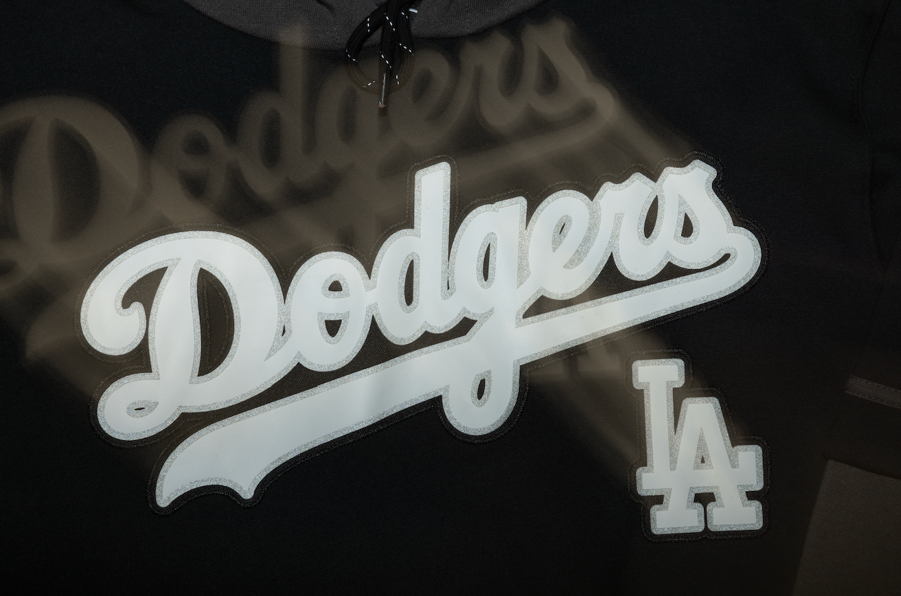 Los Angeles Dodgers team logo and LA symbol displayed in white against a dark background.